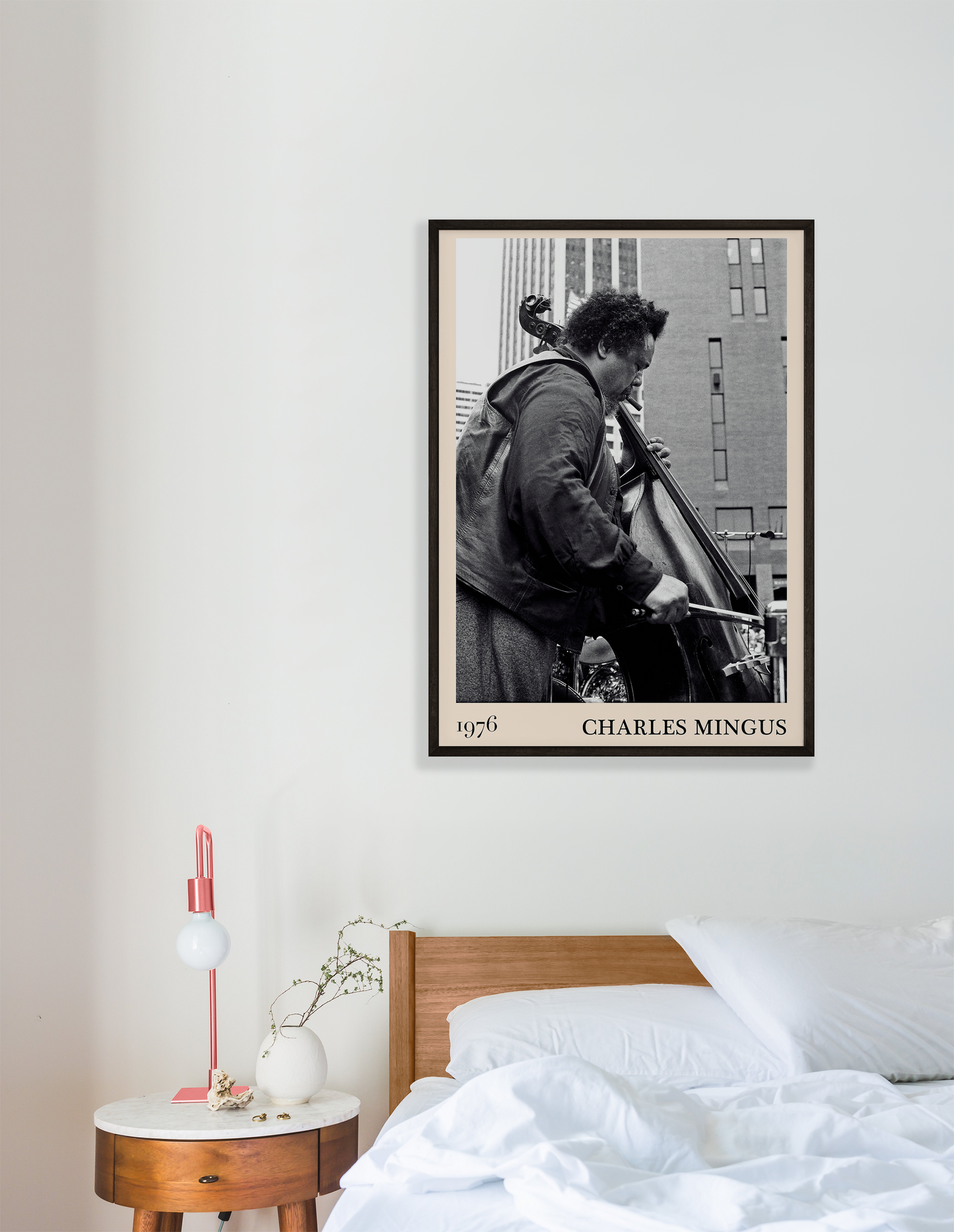 1976 photograph of Charles Mingus taken by Thomas Marcello. Picture crafted into a cool black framed music print, with an off-white border. Poster is hanging on a white bedroom wall.