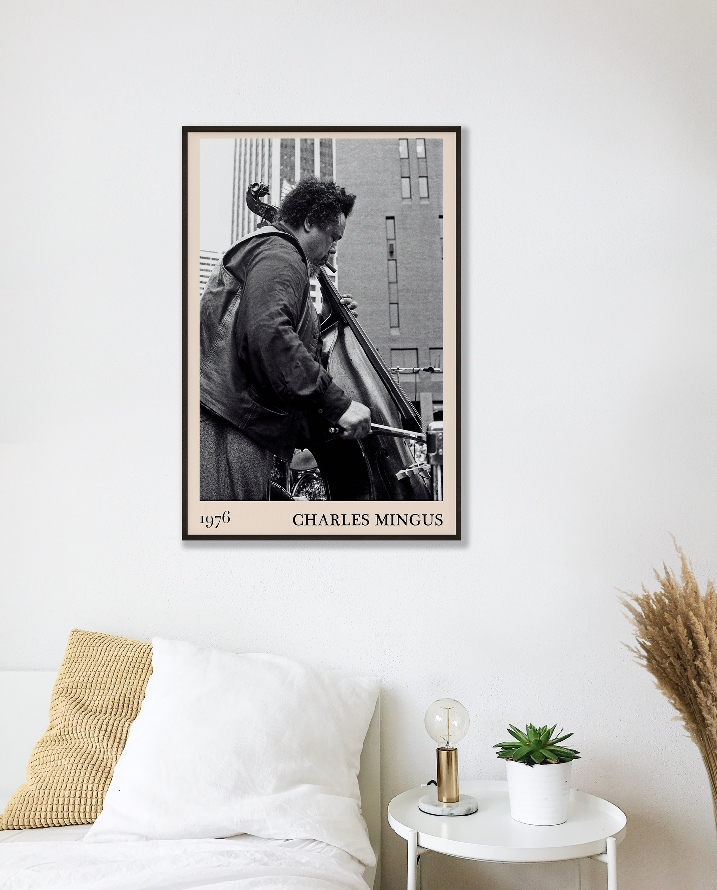 1976 photograph of Charles Mingus taken by Thomas Marcello. Picture crafted into a cool black framed music print, with an off-white border. Poster is hanging on a white bedroom wall.