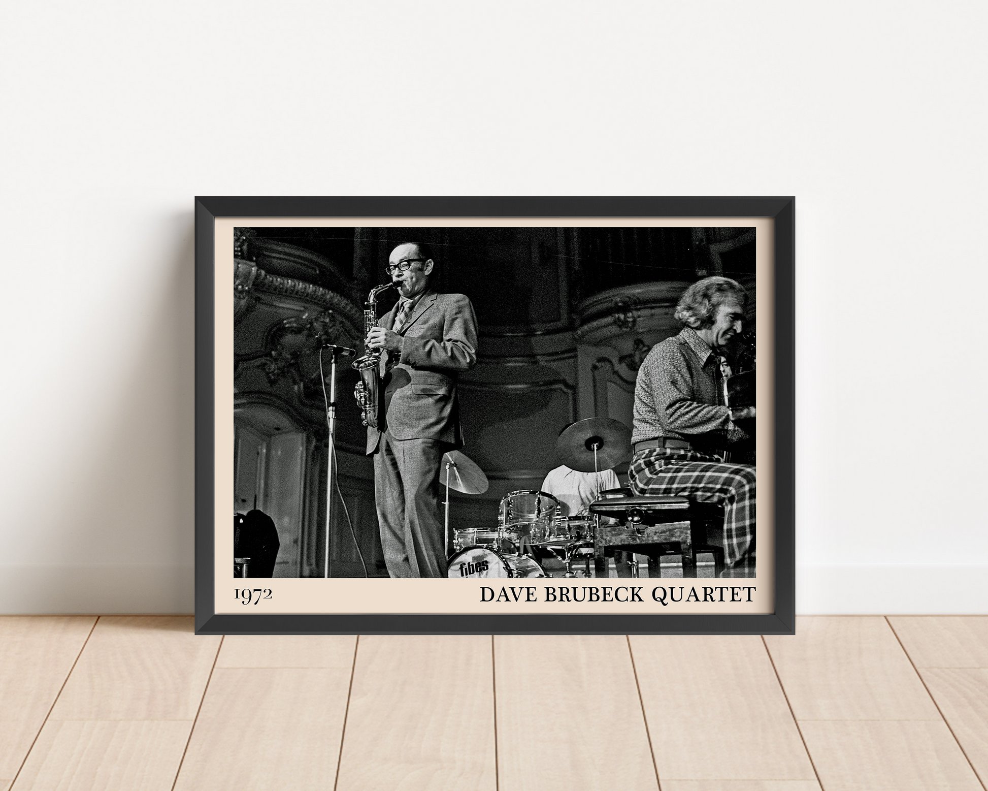 1972 photo of the Dave Brubeck Quartet crafted into a black framed-poster, leaning against a white wall