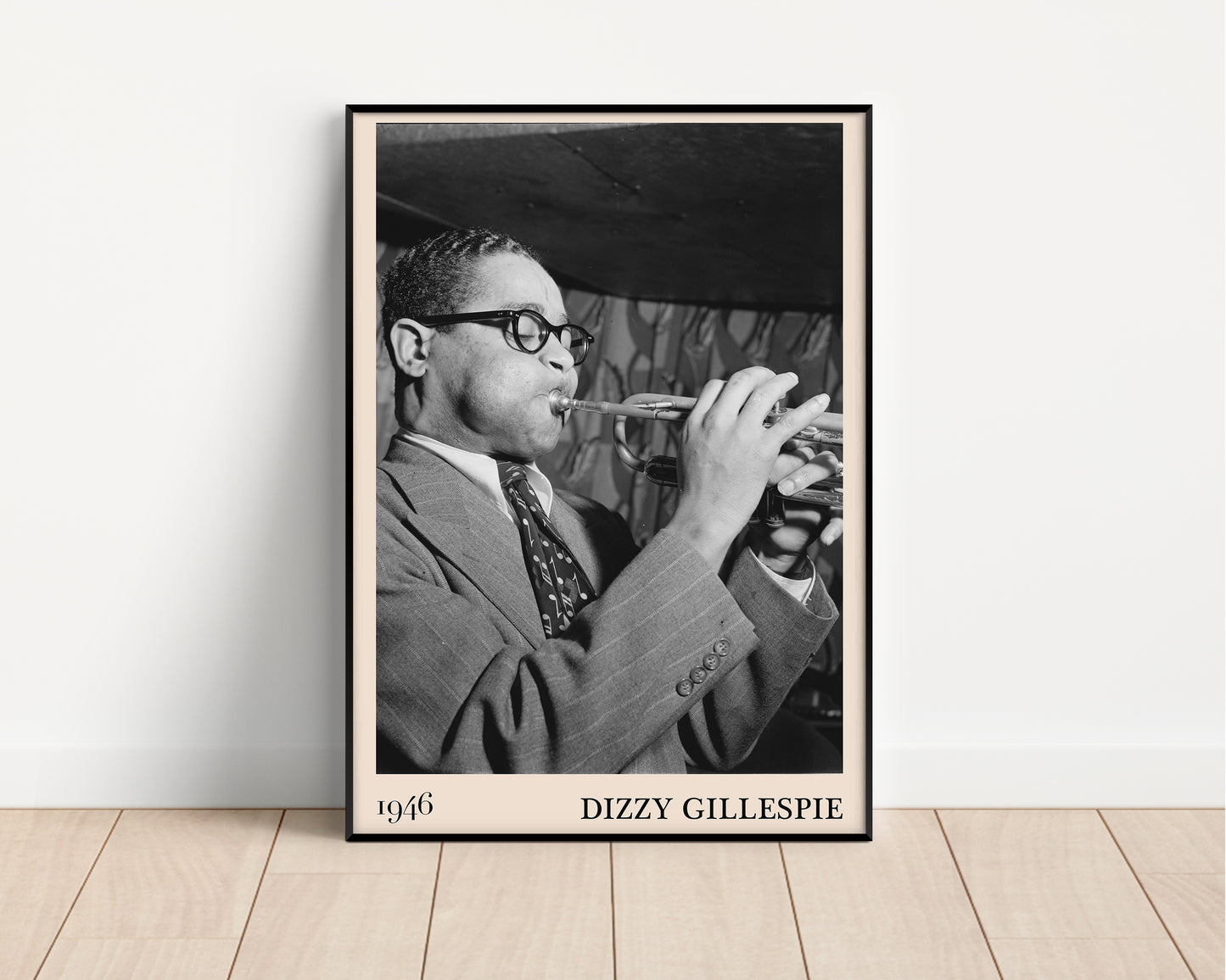 Vintage 1946 photo of Dizzy Gillespie crafted into  black framed poster, resting on a white wall