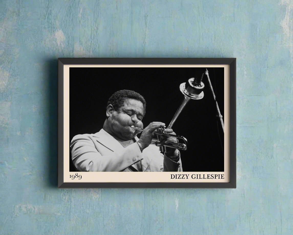 1989 photograph of Dizzy Gillespie playing the trumpet, transformed into a stylish black-framed jazz poster hanging on a blue wall