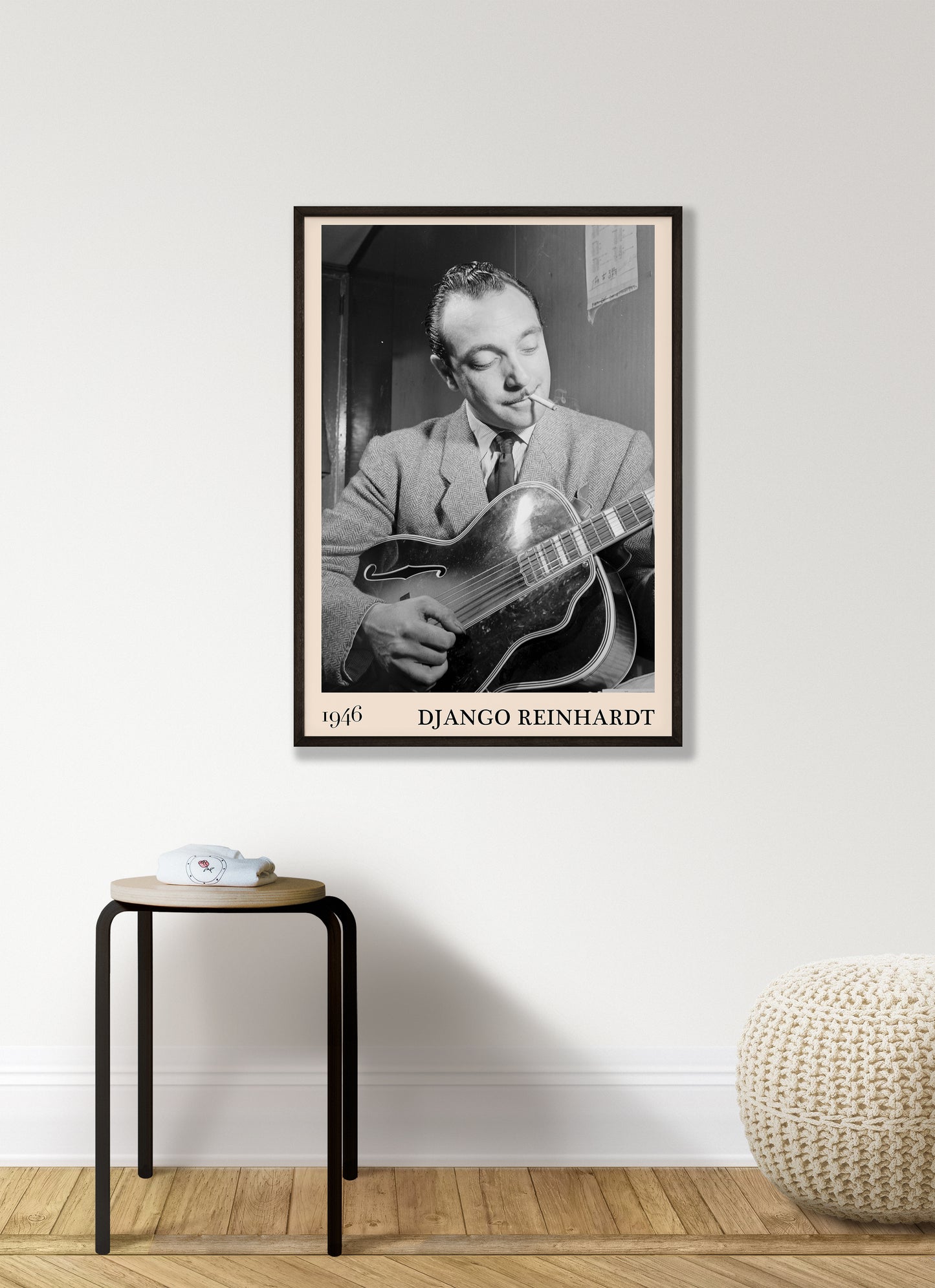 1946 photograph of Django Reinhardt playing the guitar. Transformed into a cool black-framed jazz poster hanging on a white living room wall