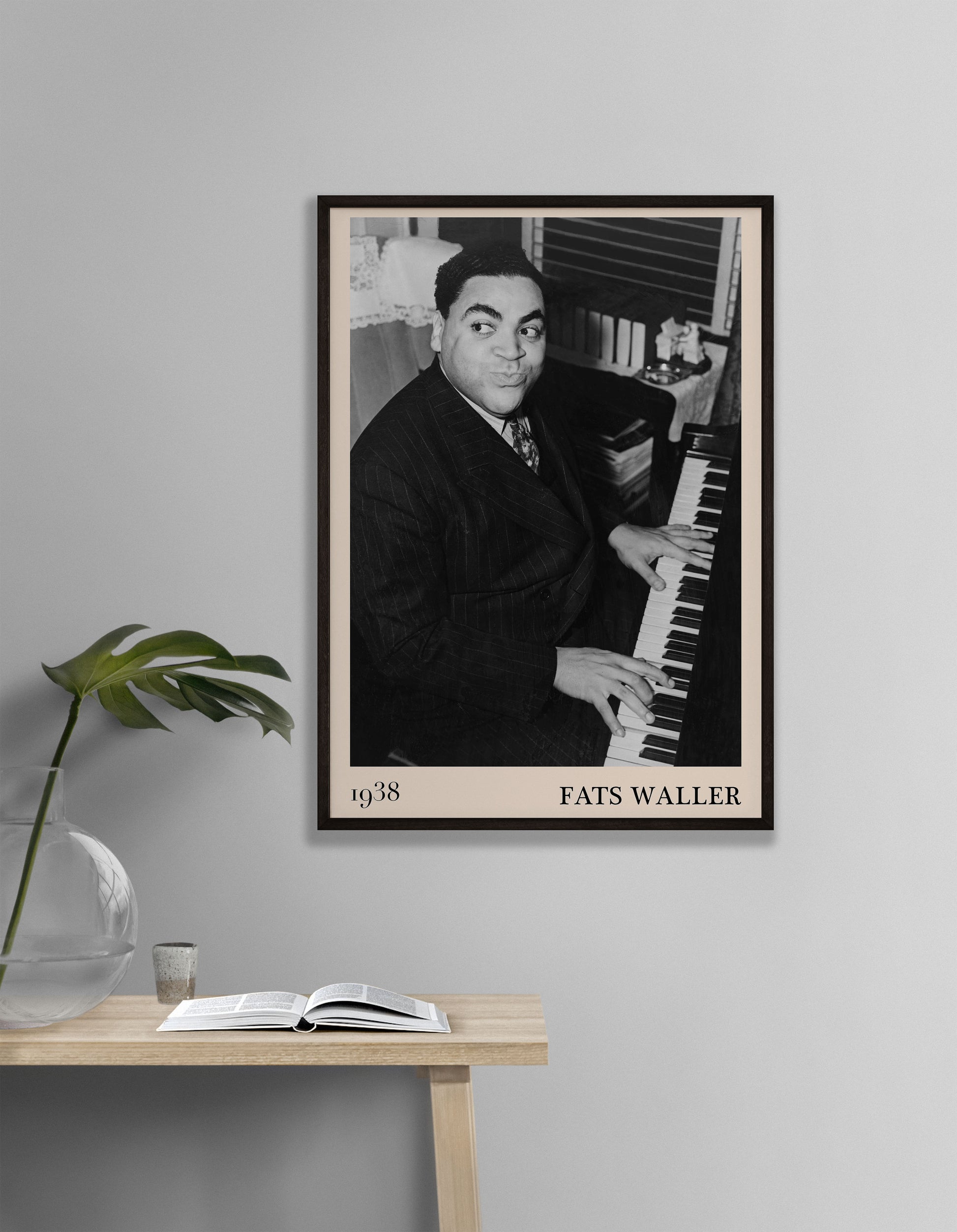 1938 photograph of Fats Waller crafted into a vintage black framed jazz poster. The poster is hanging on a grey living room wall.