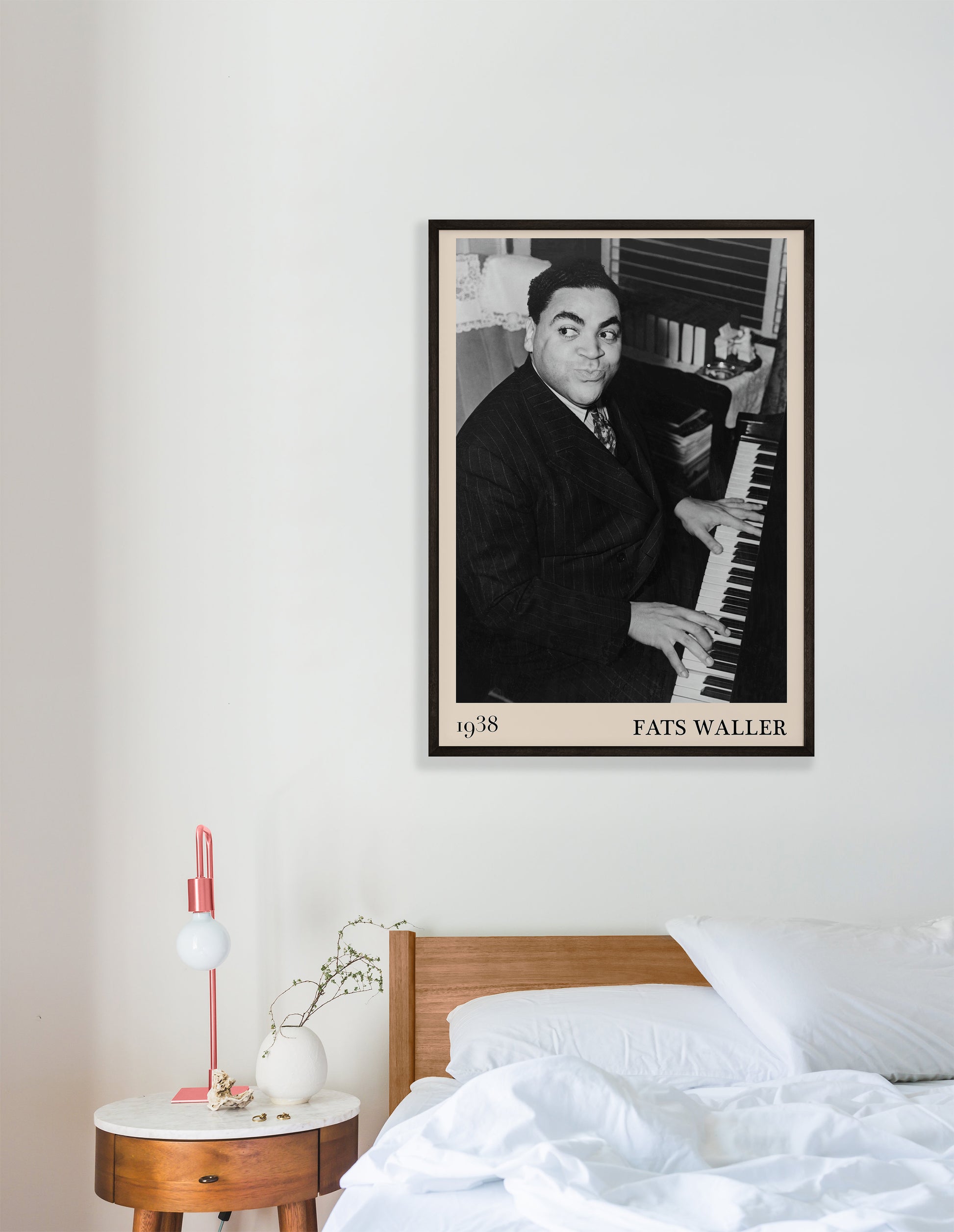 1938 photograph of Fats Waller crafted into a retro black framed art print. The poster is hanging on a white bedroom room wall.