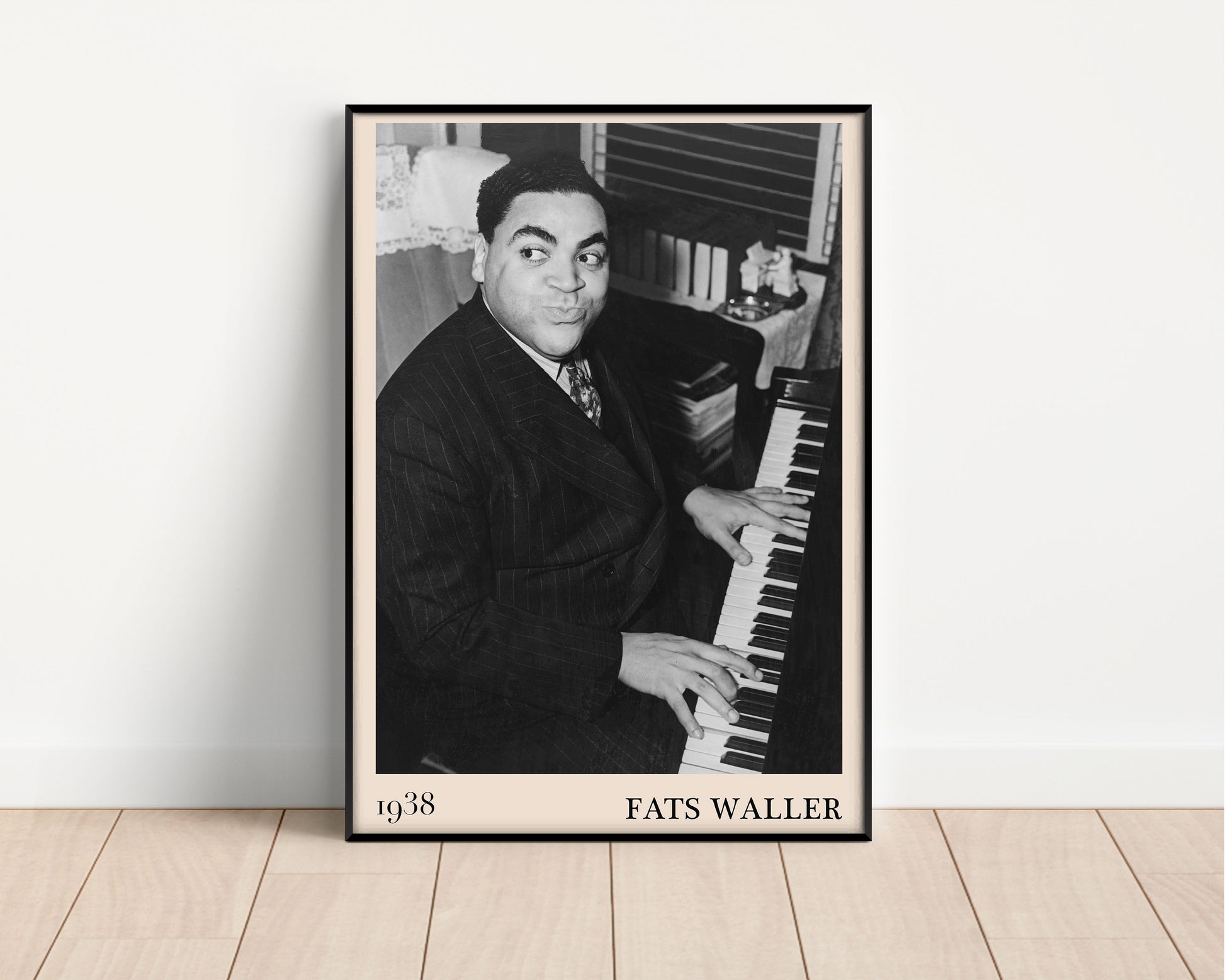 1938 photograph of Fats Waller crafted into a black framed jazz poster. The poster is resting on a white living room wall.
