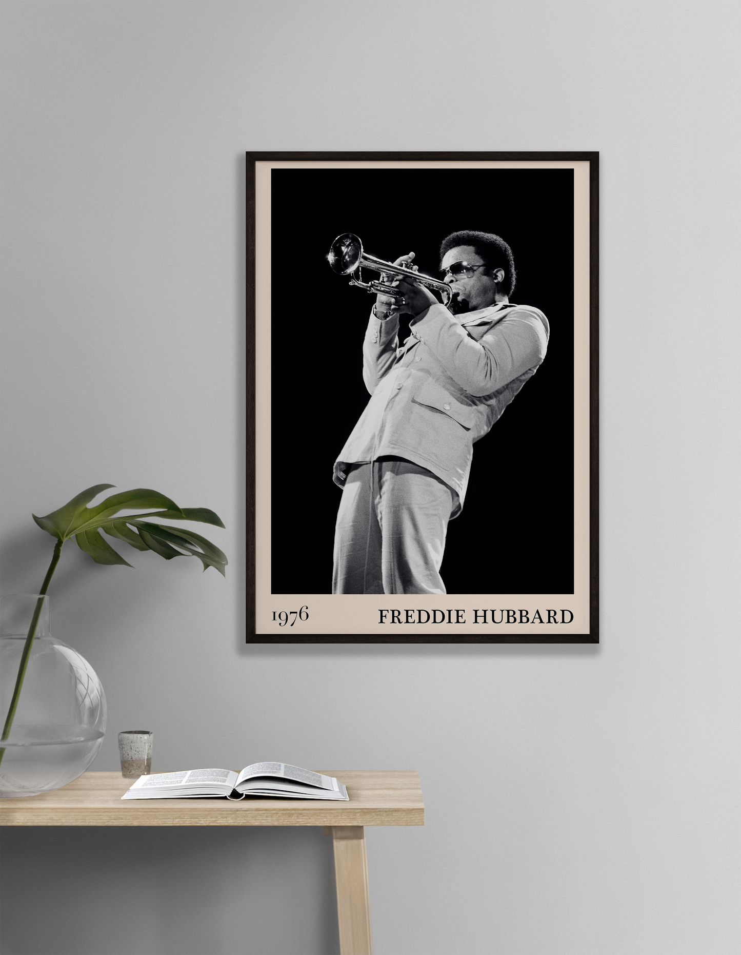 1976 photograph of Freddie Hubbard taken by Thomas Marcello. Picture crafted into a cool black framed jazz print, with an off-white border. Poster is hanging on a off-white living room wall.