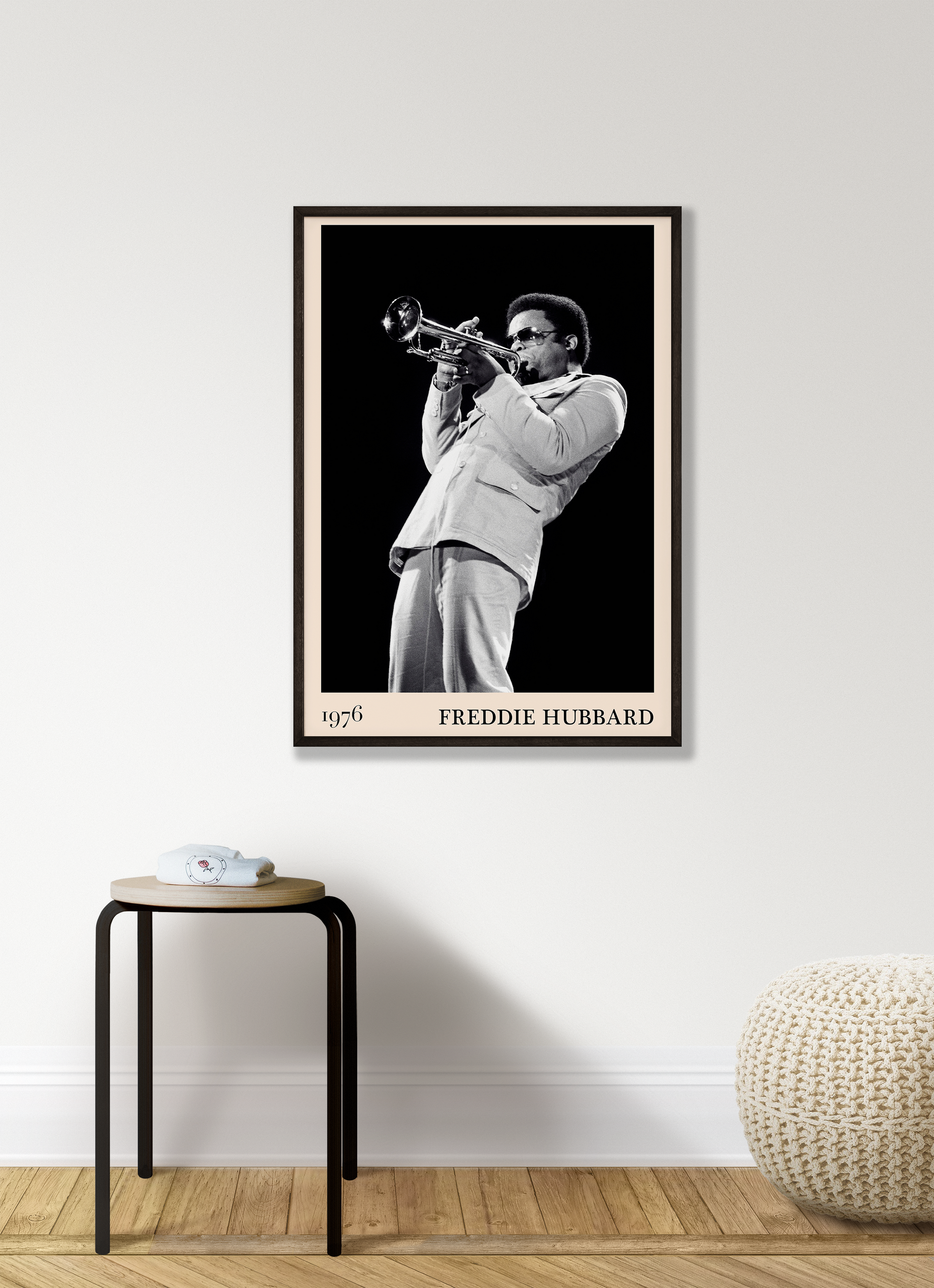 1976 photograph of Freddie Hubbard taken by Thomas Marcello. Picture crafted into a cool black framed jazz print, with an off-white border. Poster is hanging on a white living room wall.