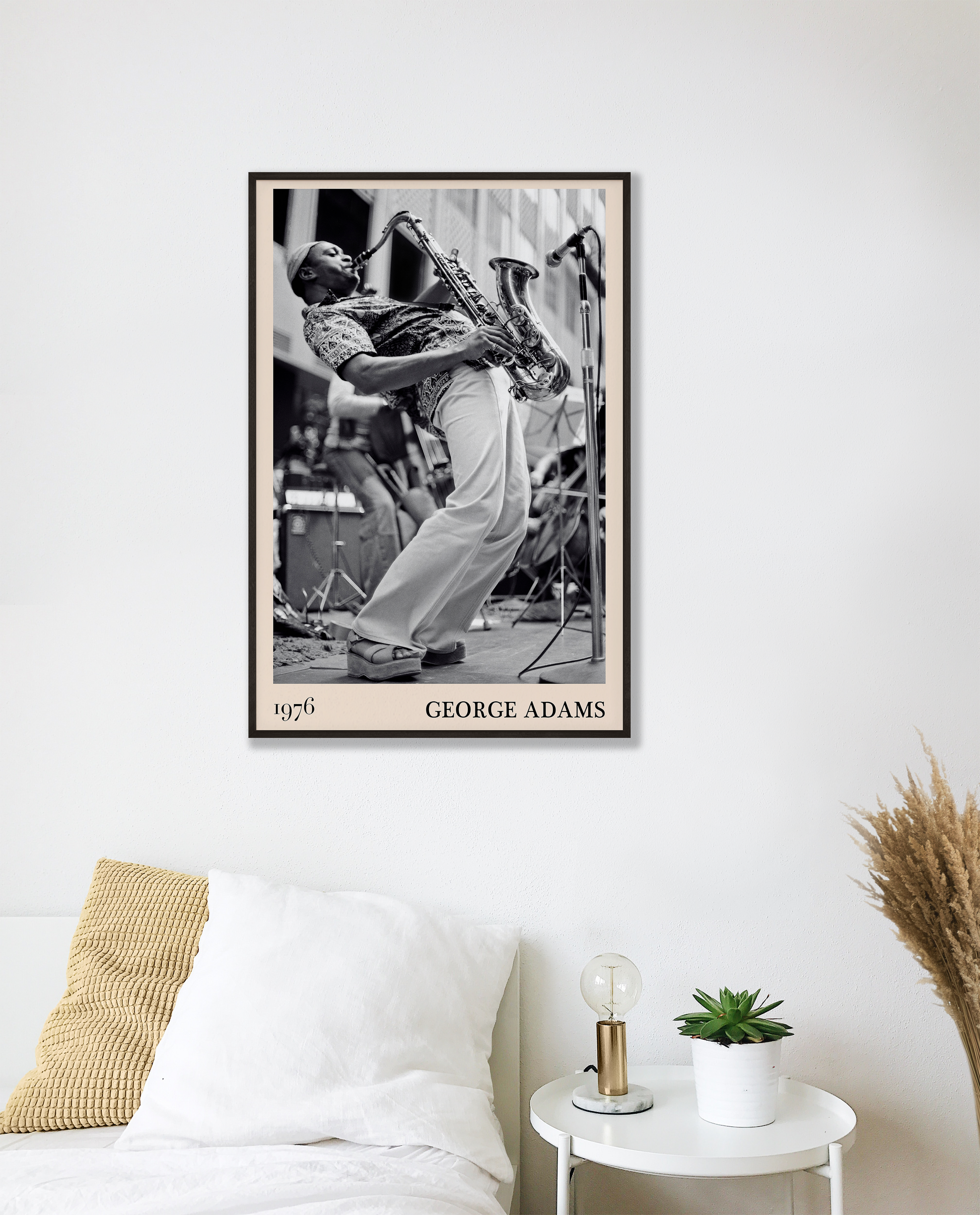 1976 photograph of George Adams taken by Thomas Marcello. Picture crafted into a cool black framed jazz print, with an off-white border. Poster is hanging on a white bedroom wall.