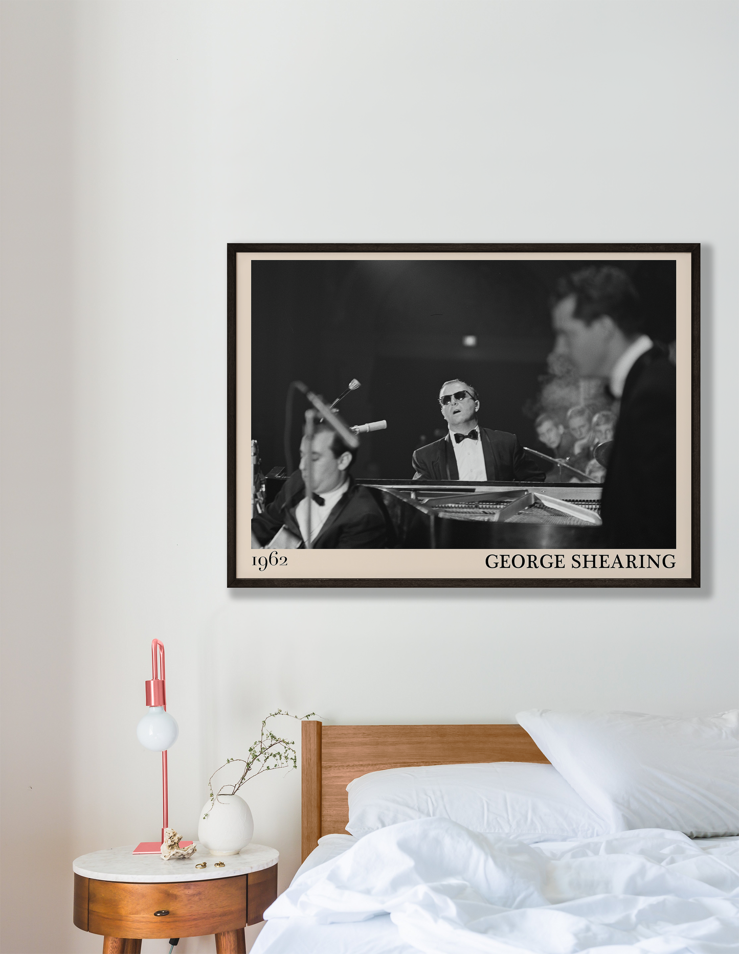 1962 picture of George Shearing playing piano. Picture crafted into a cool black framed jazz print, with an off-white border. Poster is hanging on a grey bedroom wall