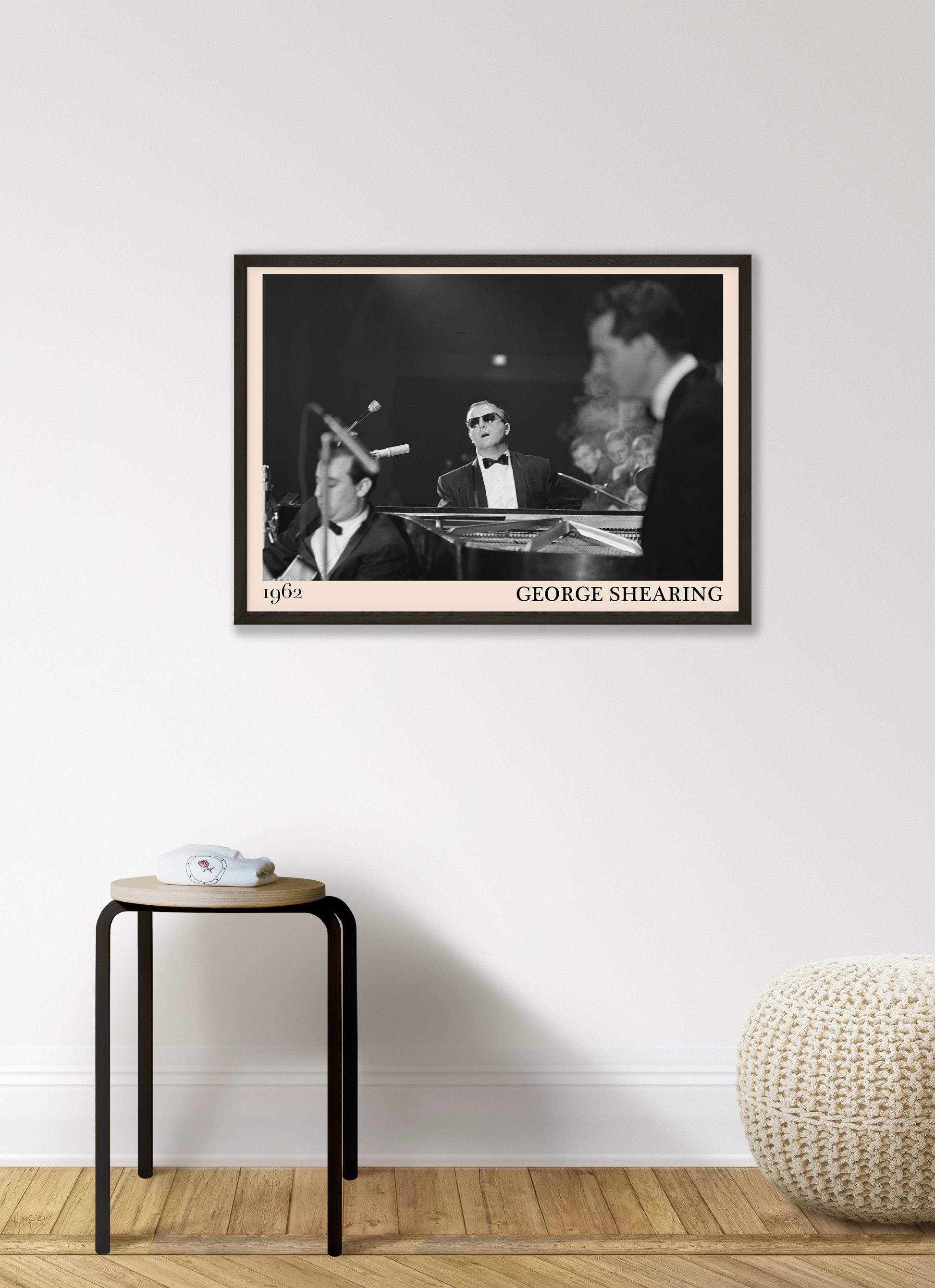 1962 picture of George Shearing playing piano. Picture crafted into a retro black framed jazz print, with an off-white border. Poster is hanging on a grey living wall