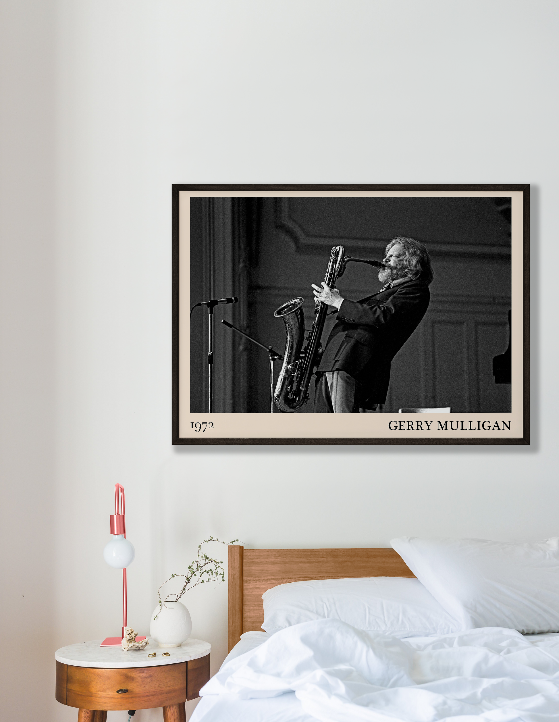 1972 photo of Gerry Mulligan crafted into a black framed-poster, hanging on a white bedroom wall