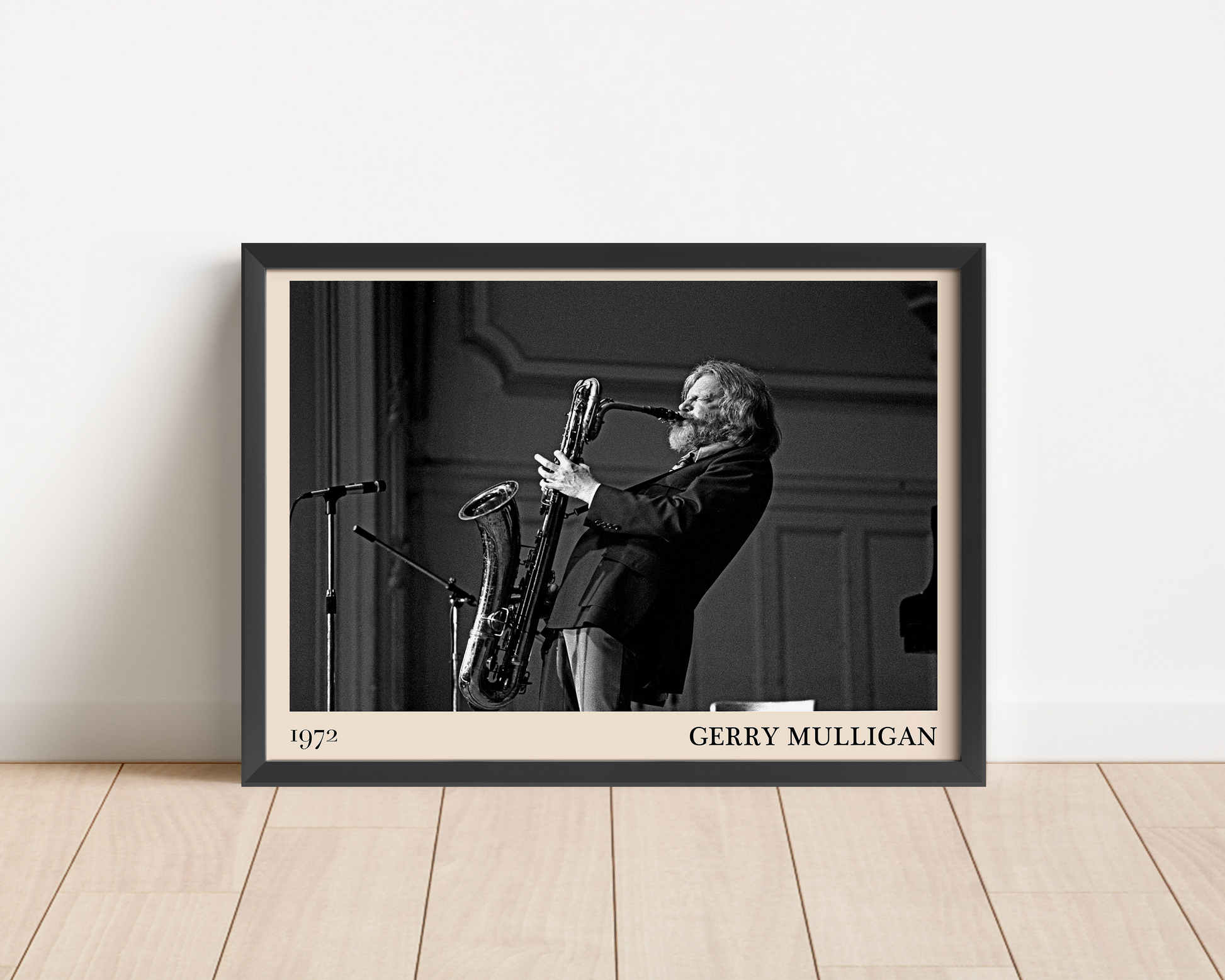 1972 photo of Gerry Mulligan crafted into a black framed-poster, leaning against a white wall