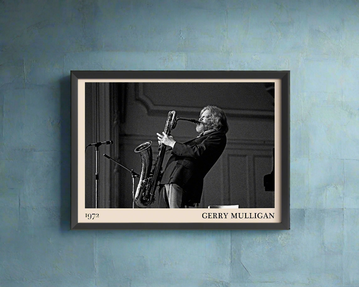 1972 photo of Gerry Mulligan crafted into a black framed-poster, hanging on a blue rustic concrete wall in dappled sunlight