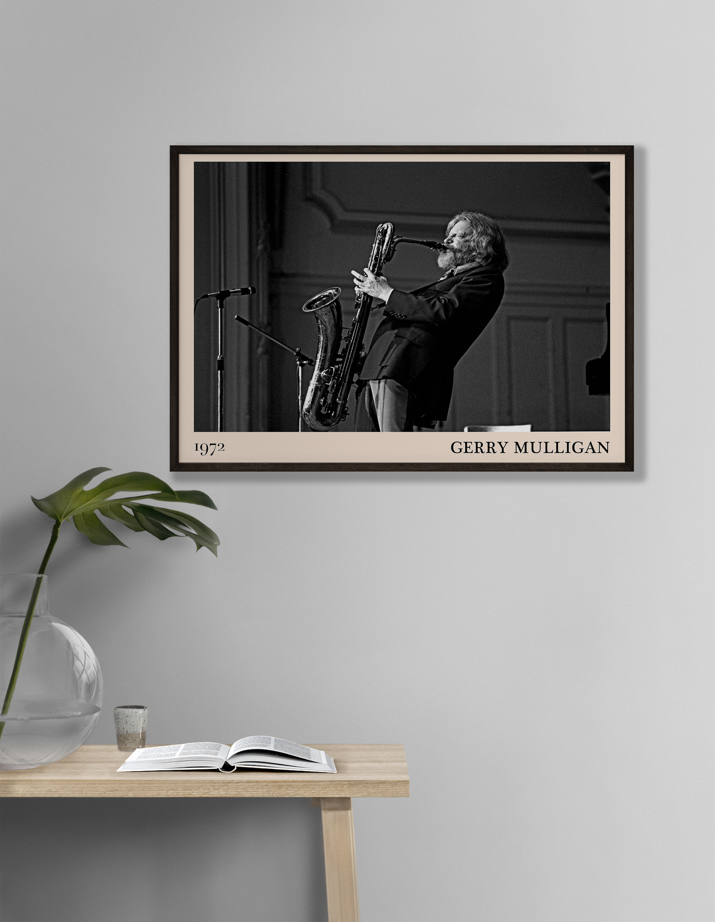 1972 photo of Gerry Mulligan crafted into a black framed-poster, hanging on a white living room wall