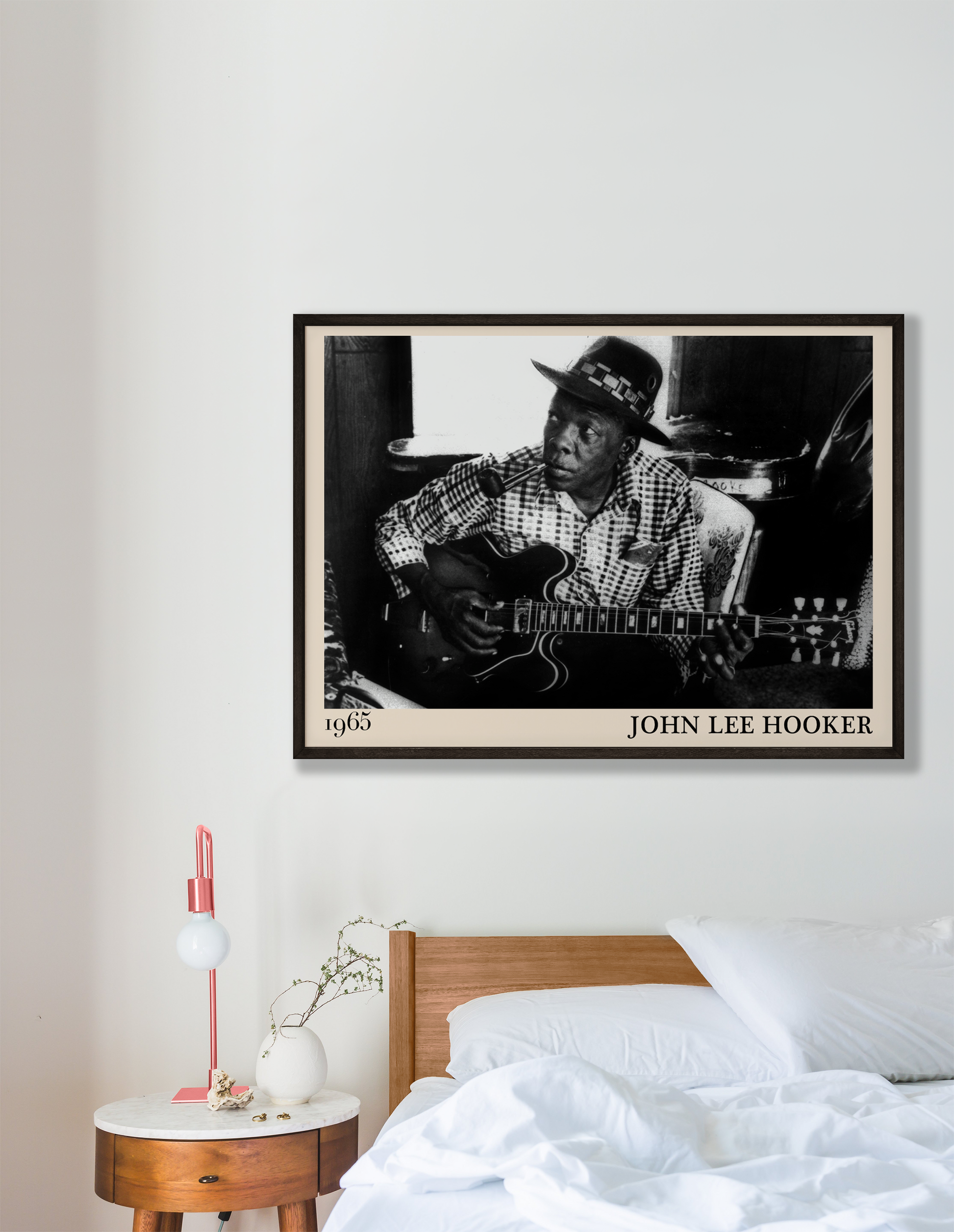 John Lee Hooker blues print hanging against a white wall in a bedroom