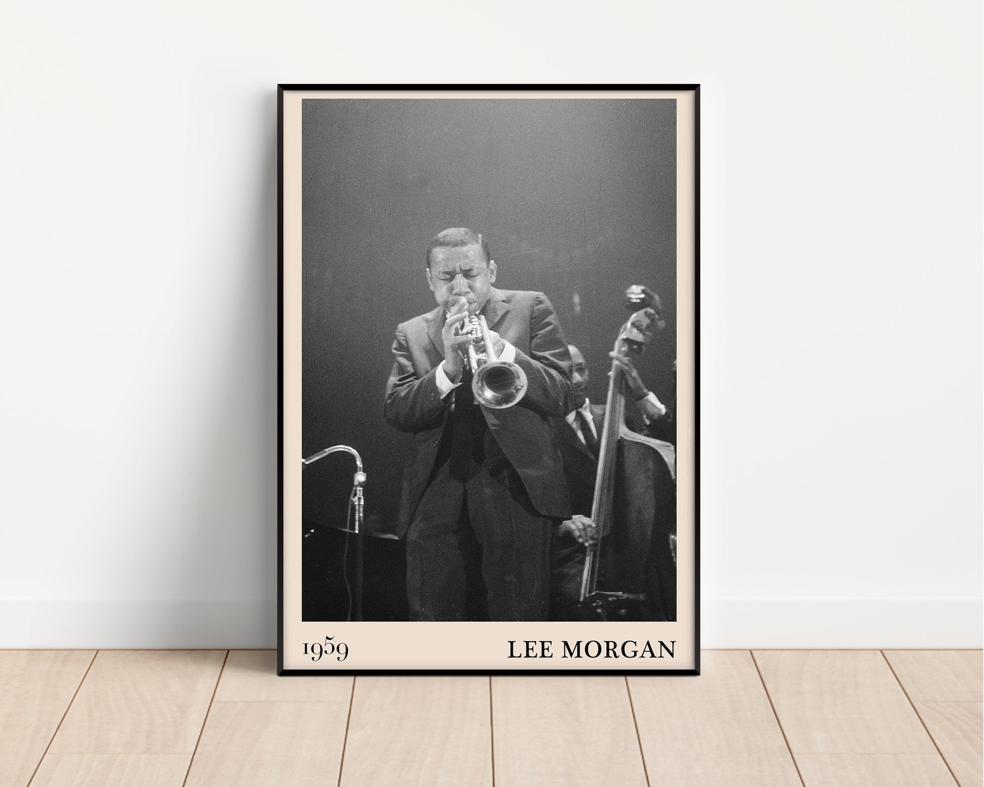 1959 photograph of Lee Morgan playing the trumpet, transformed into a stylish black-framed jazz poster resting against a white wall