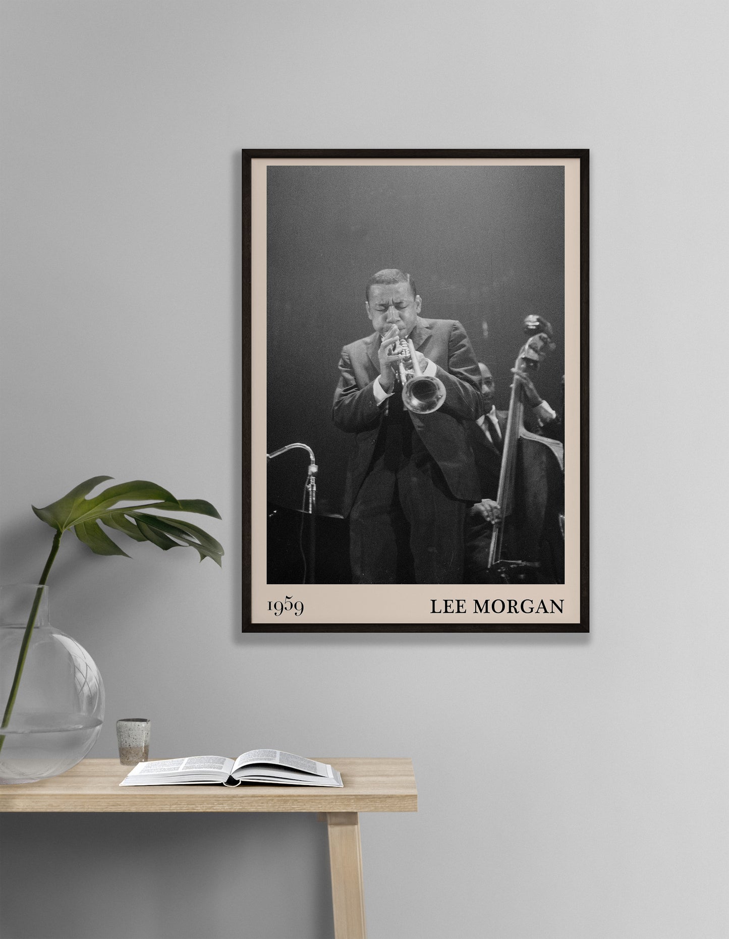 1959 photograph of Lee Morgan playing the Trumpet transformed into a stylish black-framed music poster  hanging on a grey bedroom wall