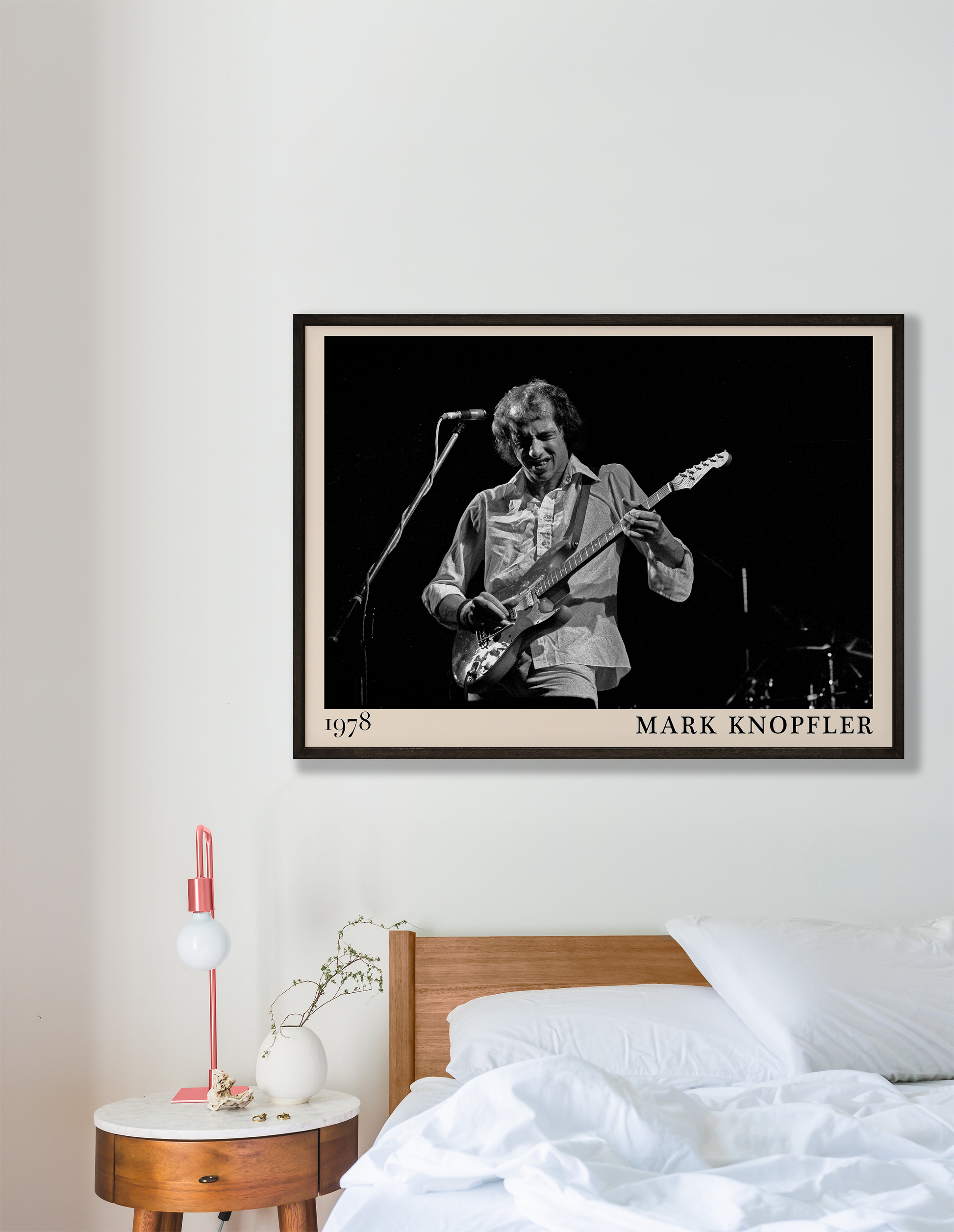 Iconic image of rock legend Mark Knopfler performing, captured by Heinrich Klaffs in 1978 and transformed into vintage-inspired wall decor hanging on a white bedroom wall