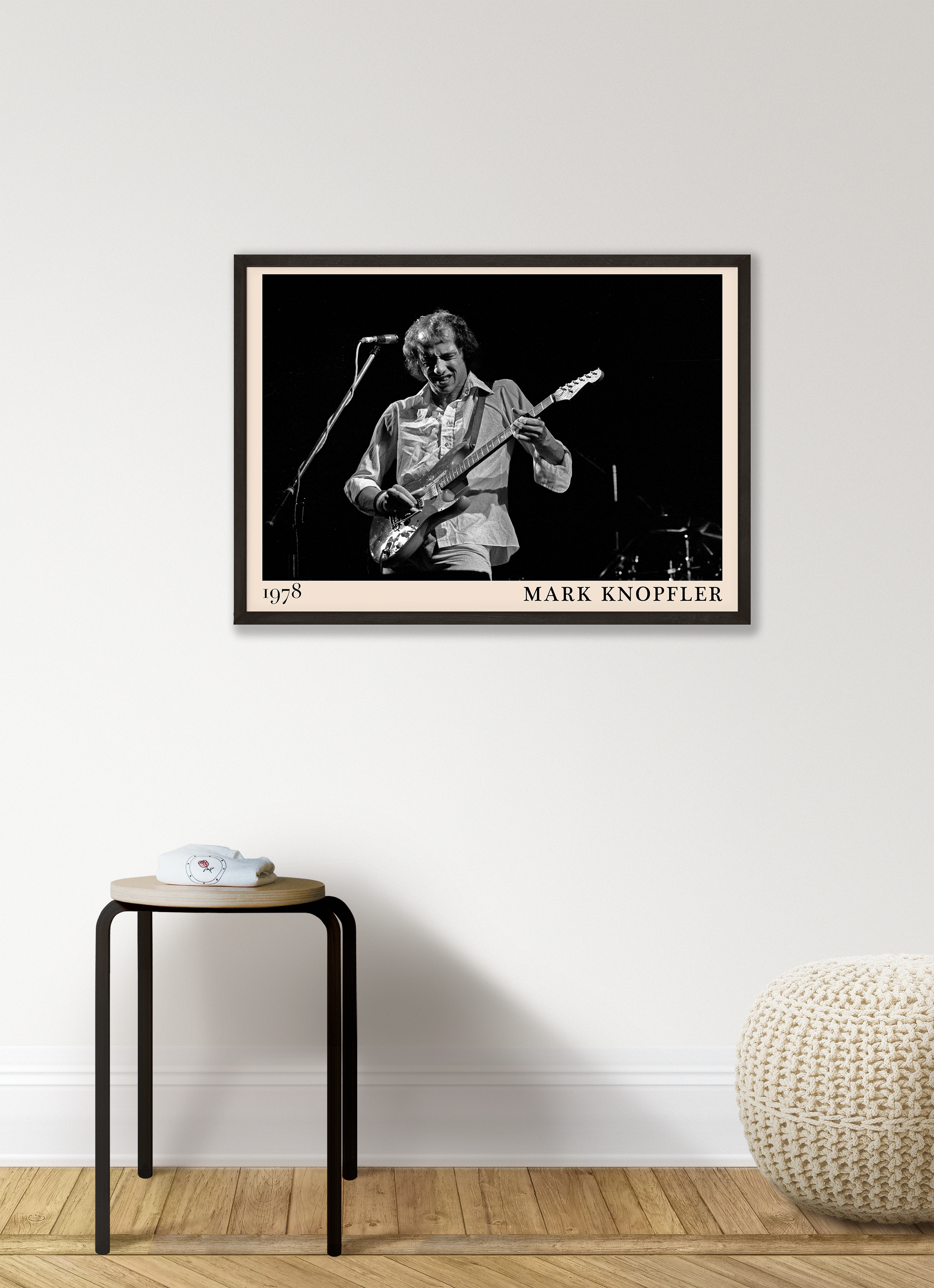 Iconic image of rock legend Mark Knopfler performing, captured by Heinrich Klaffs in 1978 and transformed into vintage-inspired wall decor hanging on a white living room wall
