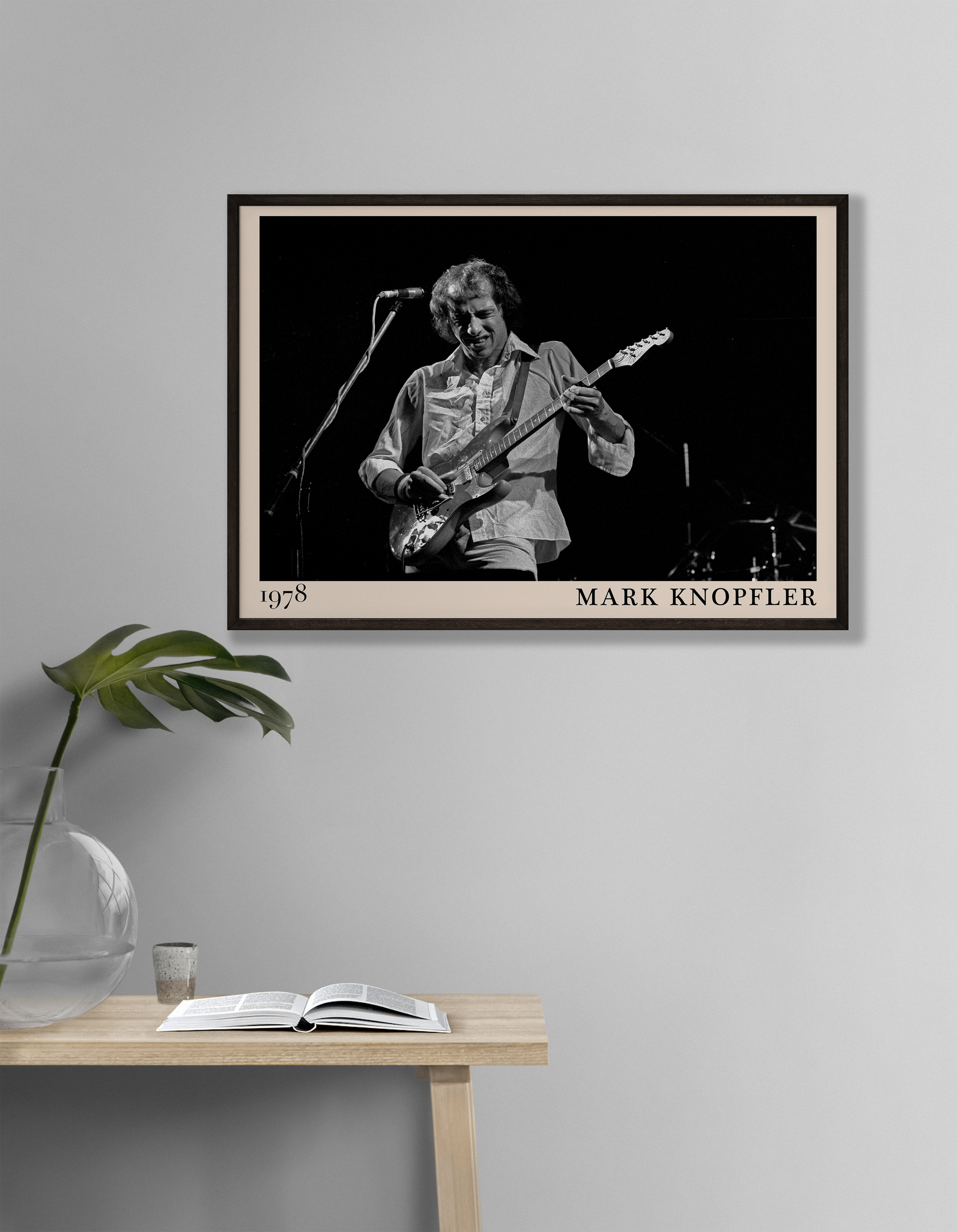 Iconic image of rock legend Mark Knopfler performing, captured by Heinrich Klaffs in 1978 and transformed into vintage-inspired wall decor hanging on a white living room wall
