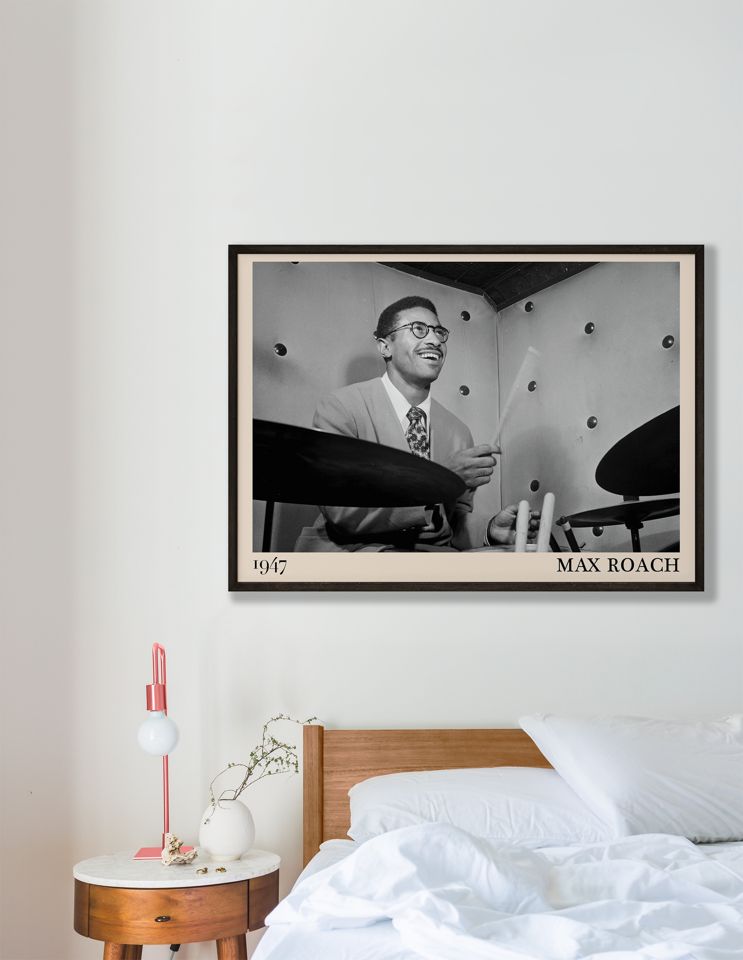 1947 photograph of Sonny Rollins playing the drums, transformed into a retro black-framed jazz poster hanging on a white bedroom wall
