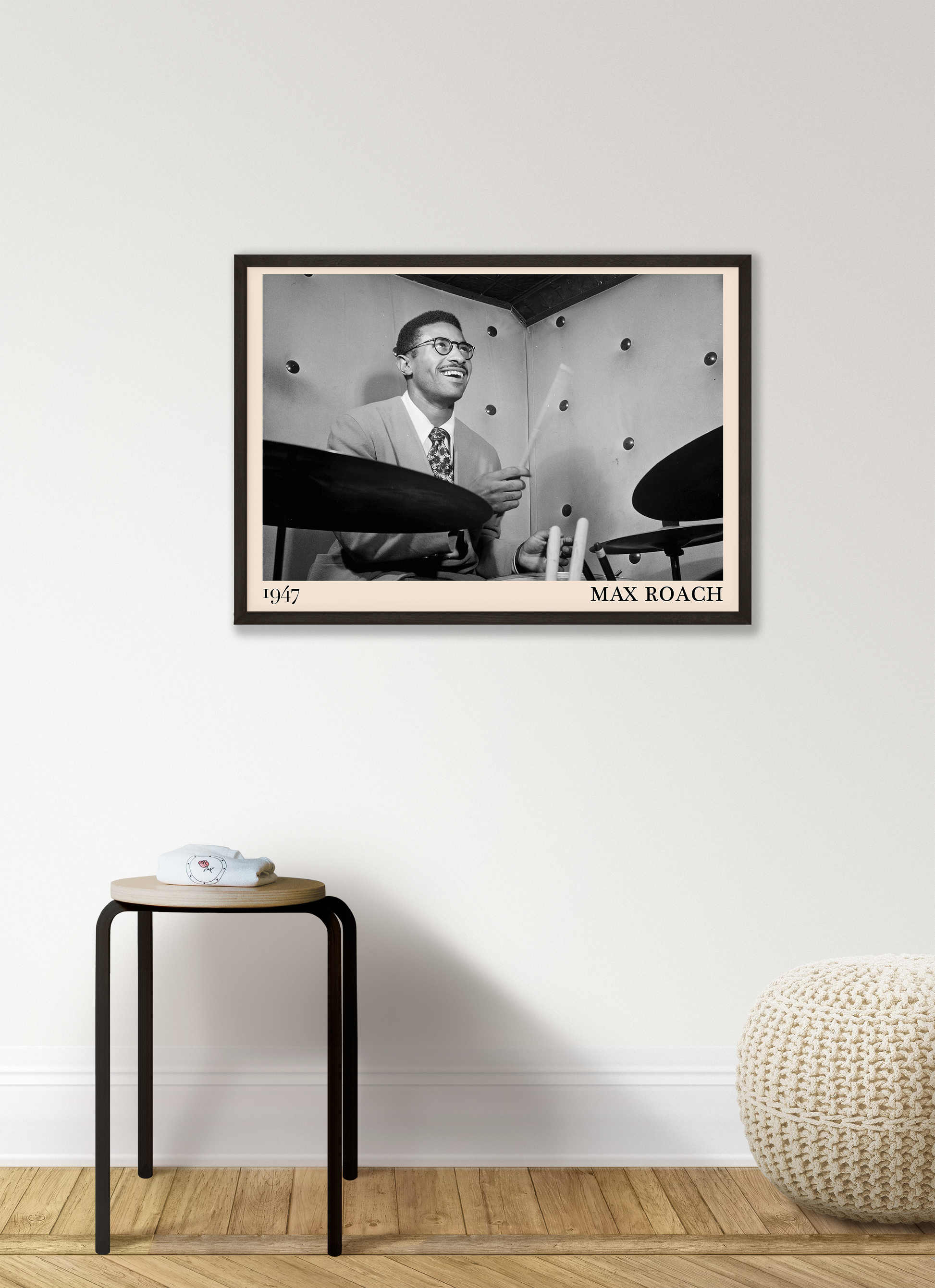 1947 photograph of Sonny Rollins playing the drums, transformed into a retro black-framed jazz poster hanging on a white living room wall