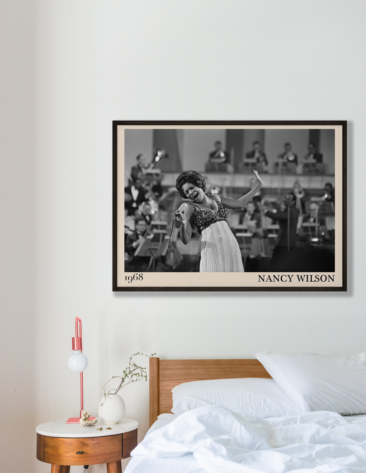 1968 picture of Nancy Wilson singing. Picture crafted into a cool black framed jazz print, with an off-white border. Poster is hanging on a grey bedroom wall