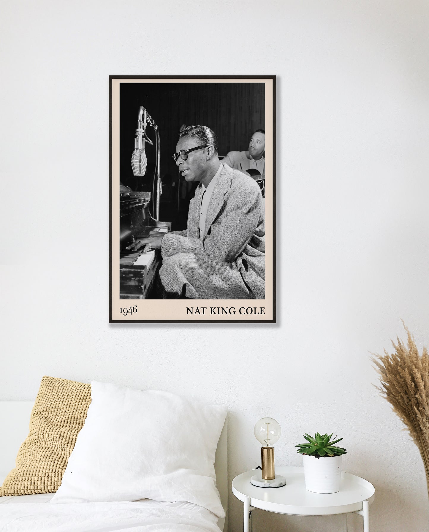 1946 picture of Nat King Cole playing a piano and singing. Picture crafted into a cool black framed jazz print, with an off-white border. Poster is hanging on a white bedroom wall