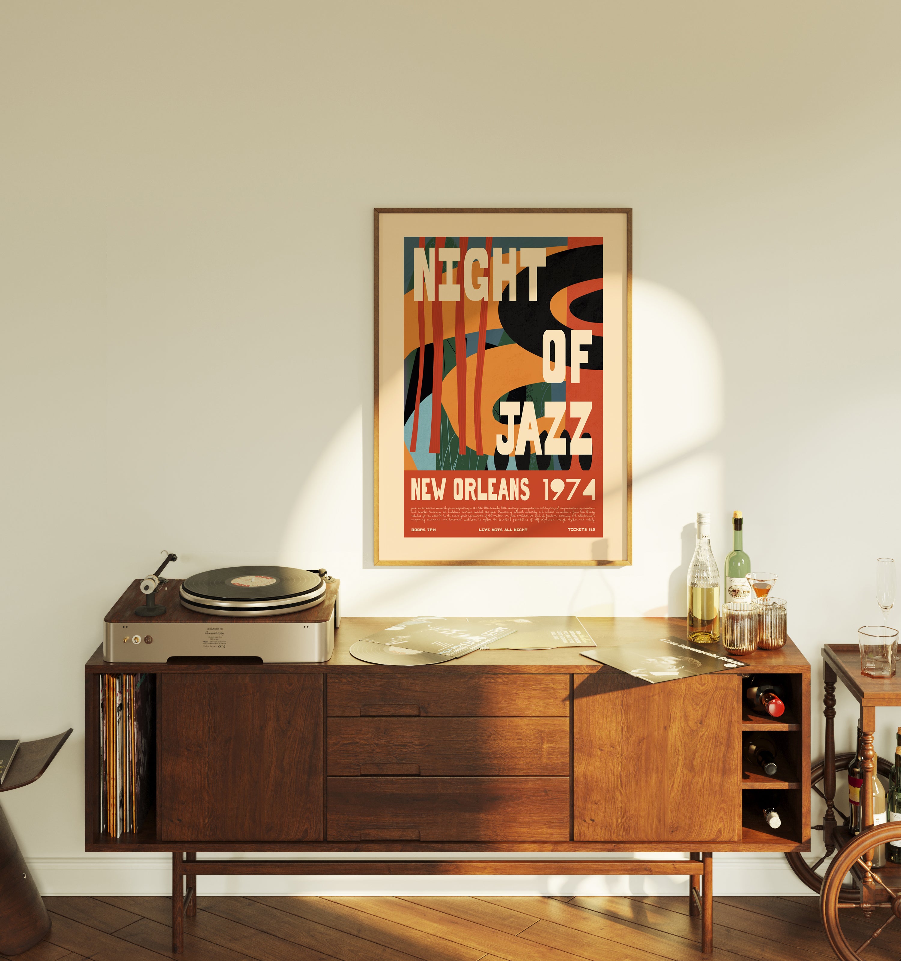 Wooden sideboard with a record player, framed poster, and bottles on a light-colored wall.