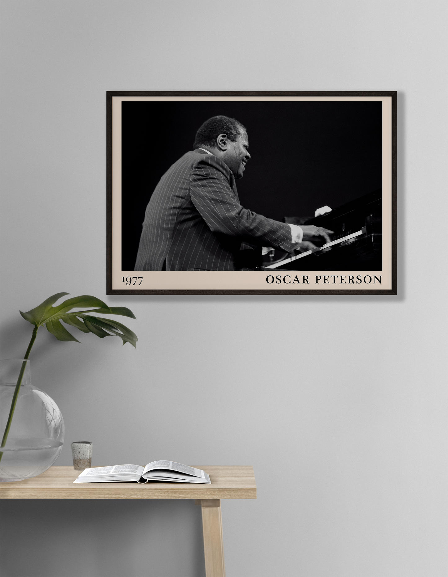 1977 photograph of Oscar Peterson taken by Thomas Marcello. Picture crafted into a cool black framed jazz print, with an off-white border. Poster is hanging on a off-white living room wall