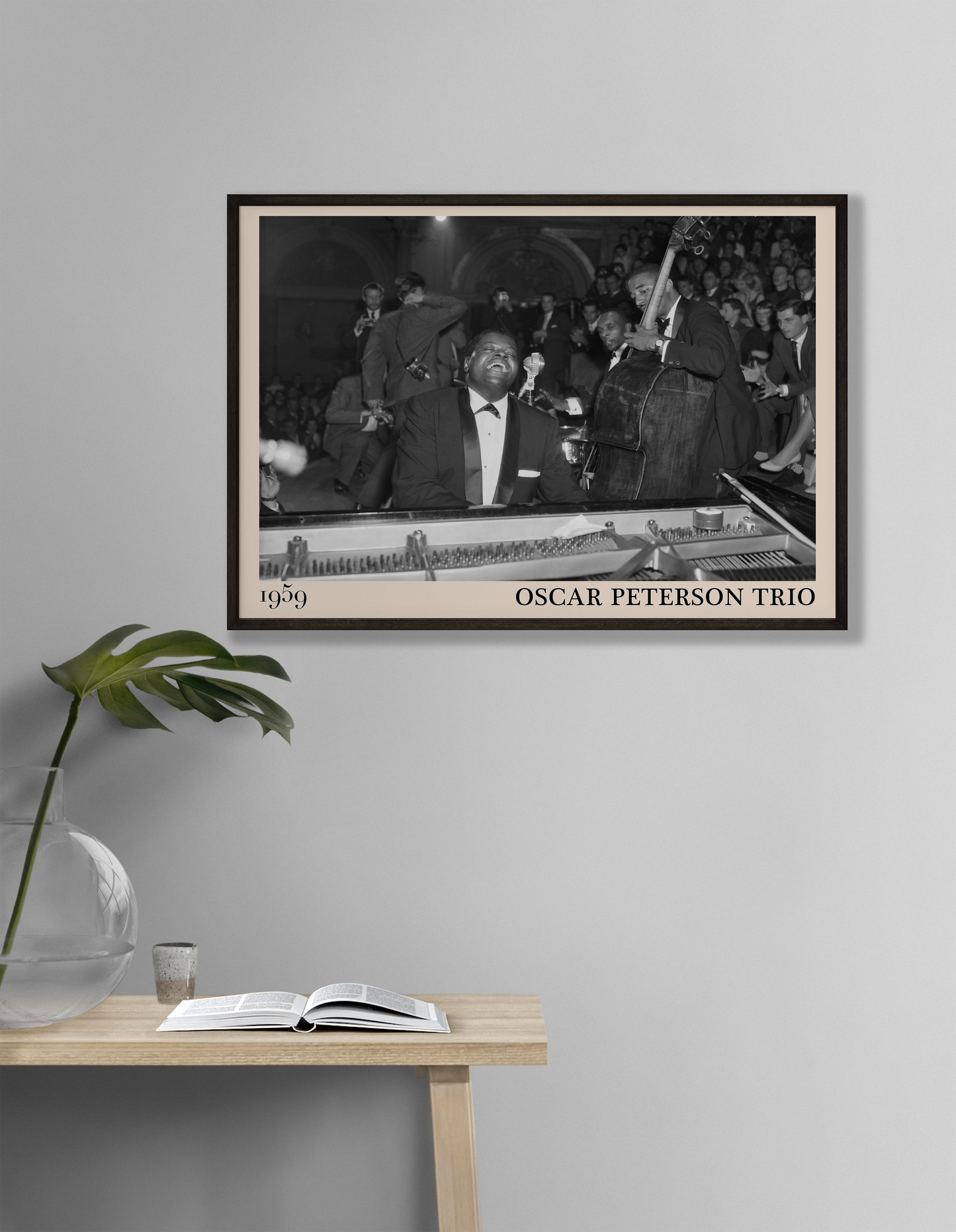 1959 picture of the Oscar Peterson Trio. Picture crafted into a cool black framed jazz print, with an off-white border. Poster is hanging on a grey living room wall