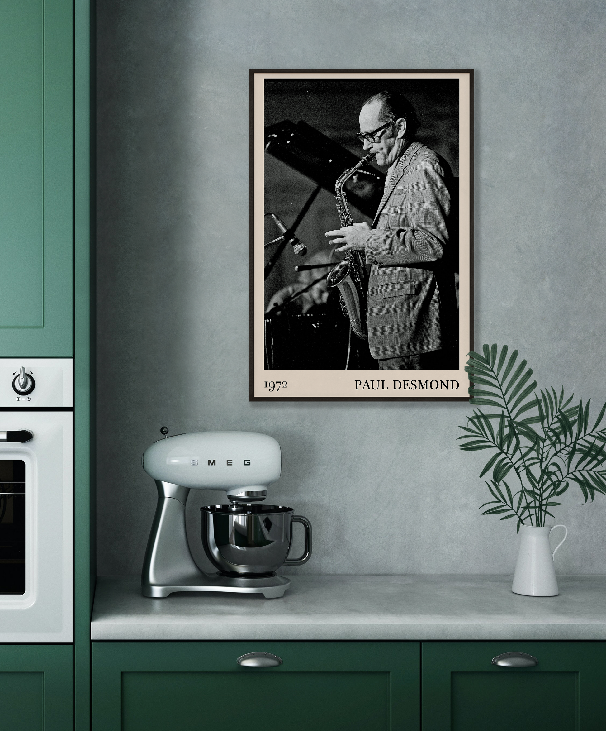 1972 photo of Paul Desmond crafted into a black framed-poster, hanging on a grey kitchen wall