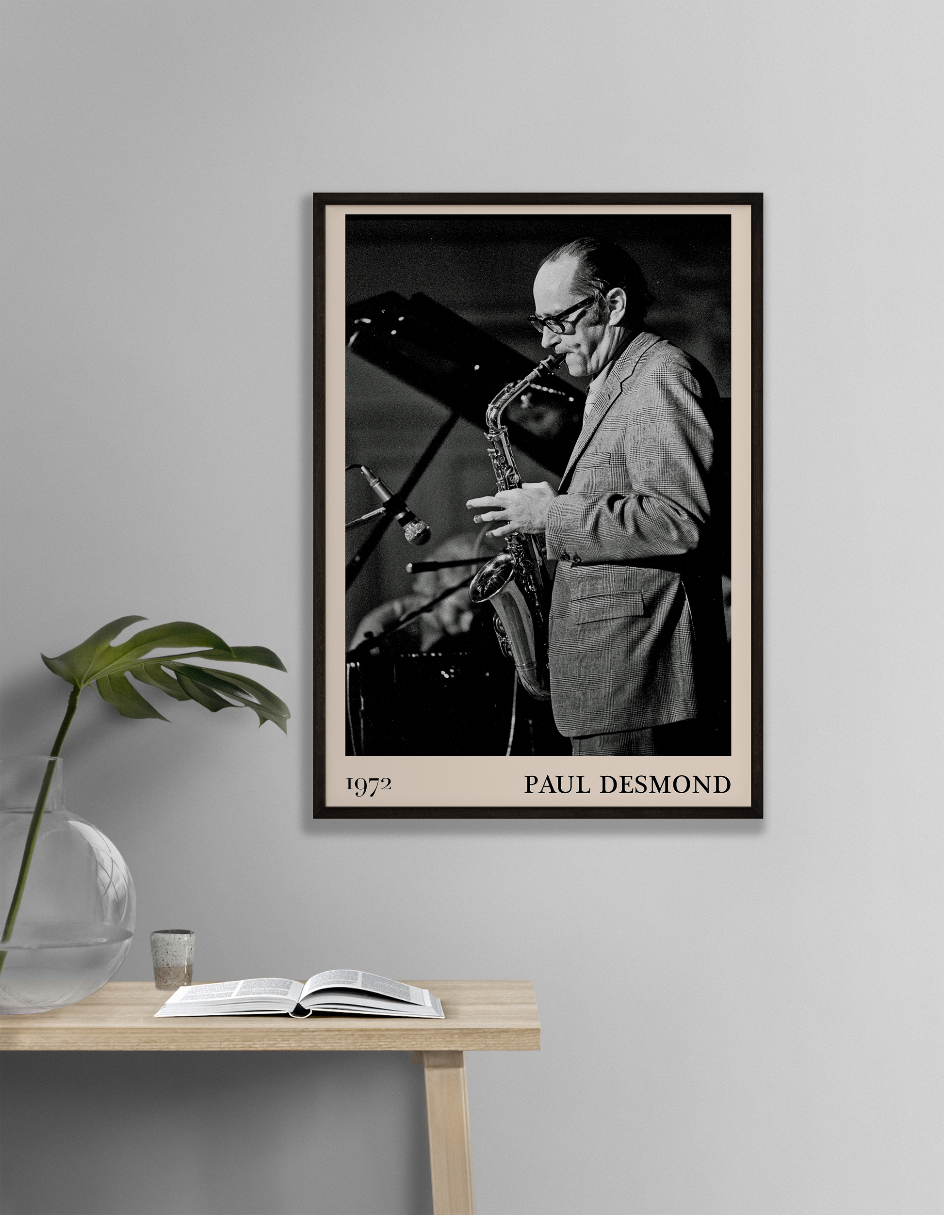 1972 photo of Paul Desmond crafted into a black framed-poster, hanging on a white living room wall