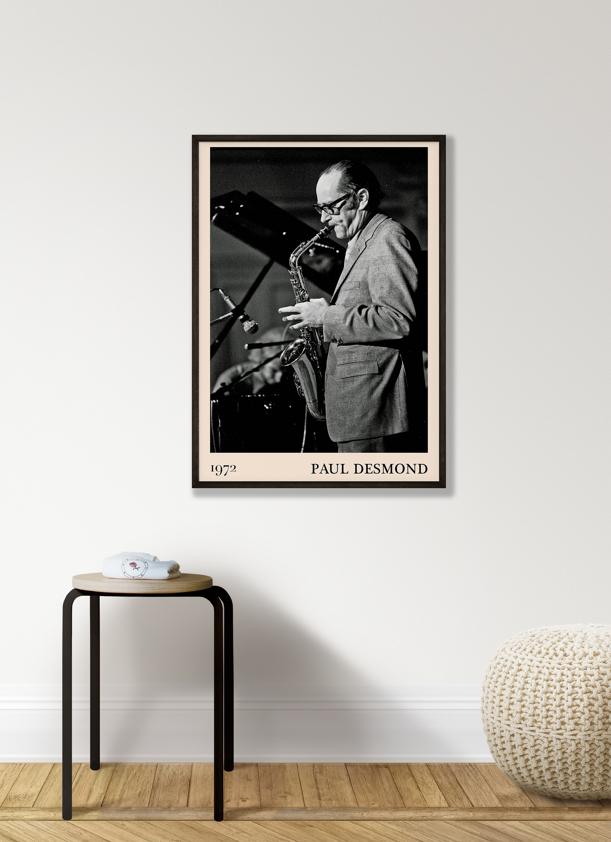 1972 photo of Paul Desmond crafted into a black framed-poster, hanging on a white living room wall