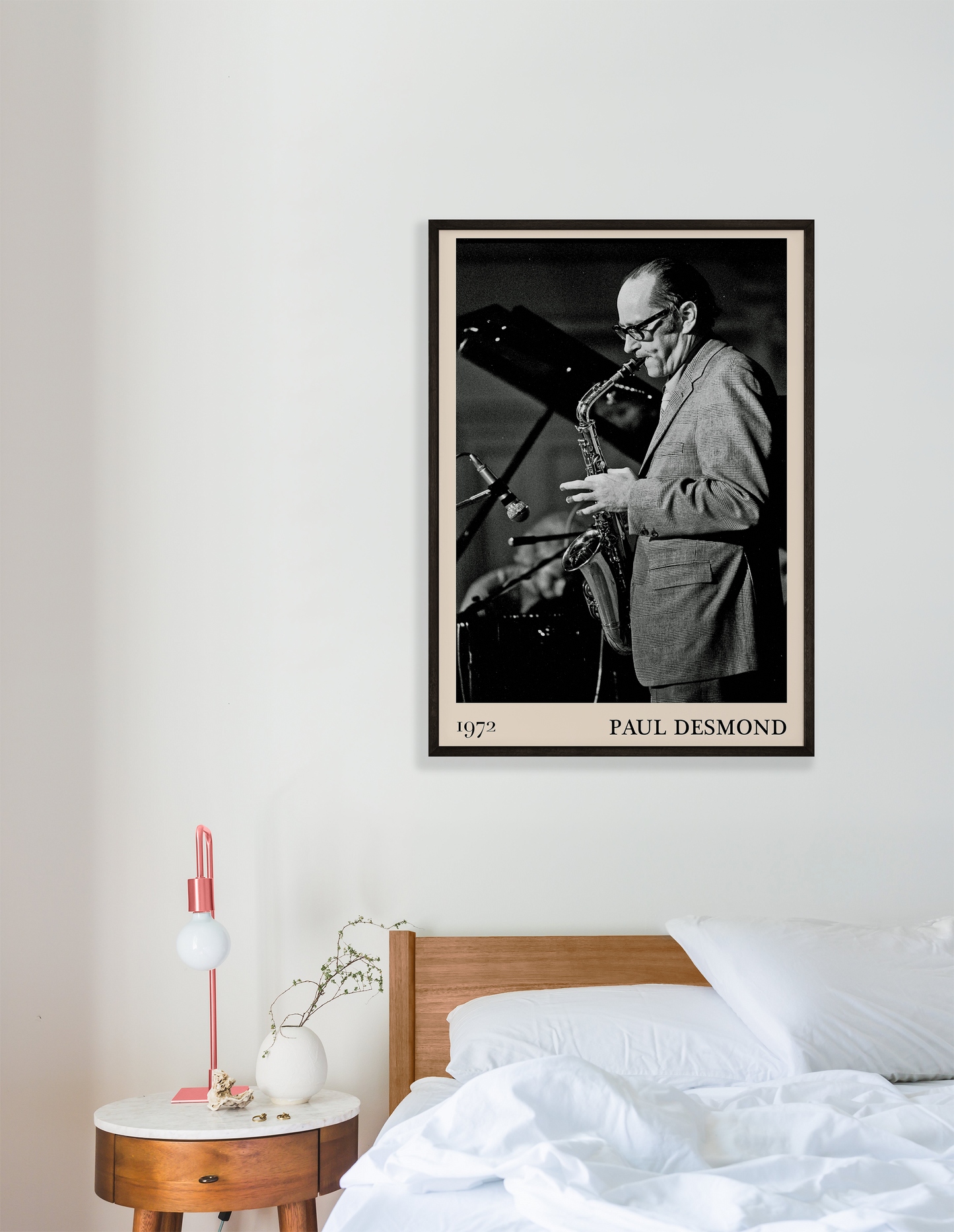 1972 photo of Paul Desmond crafted into a black framed-poster, hanging on a white bedroom wall