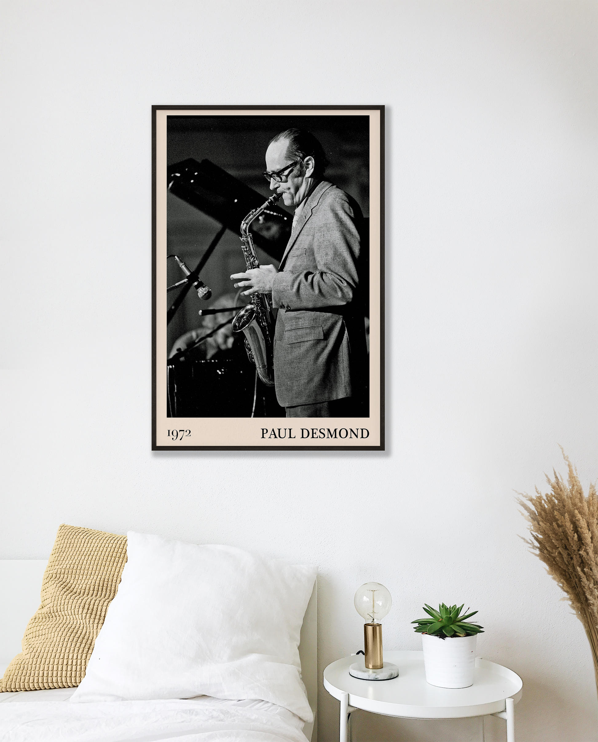 1972 photo of Paul Desmond crafted into a black framed-poster, hanging on a white bedroom wall