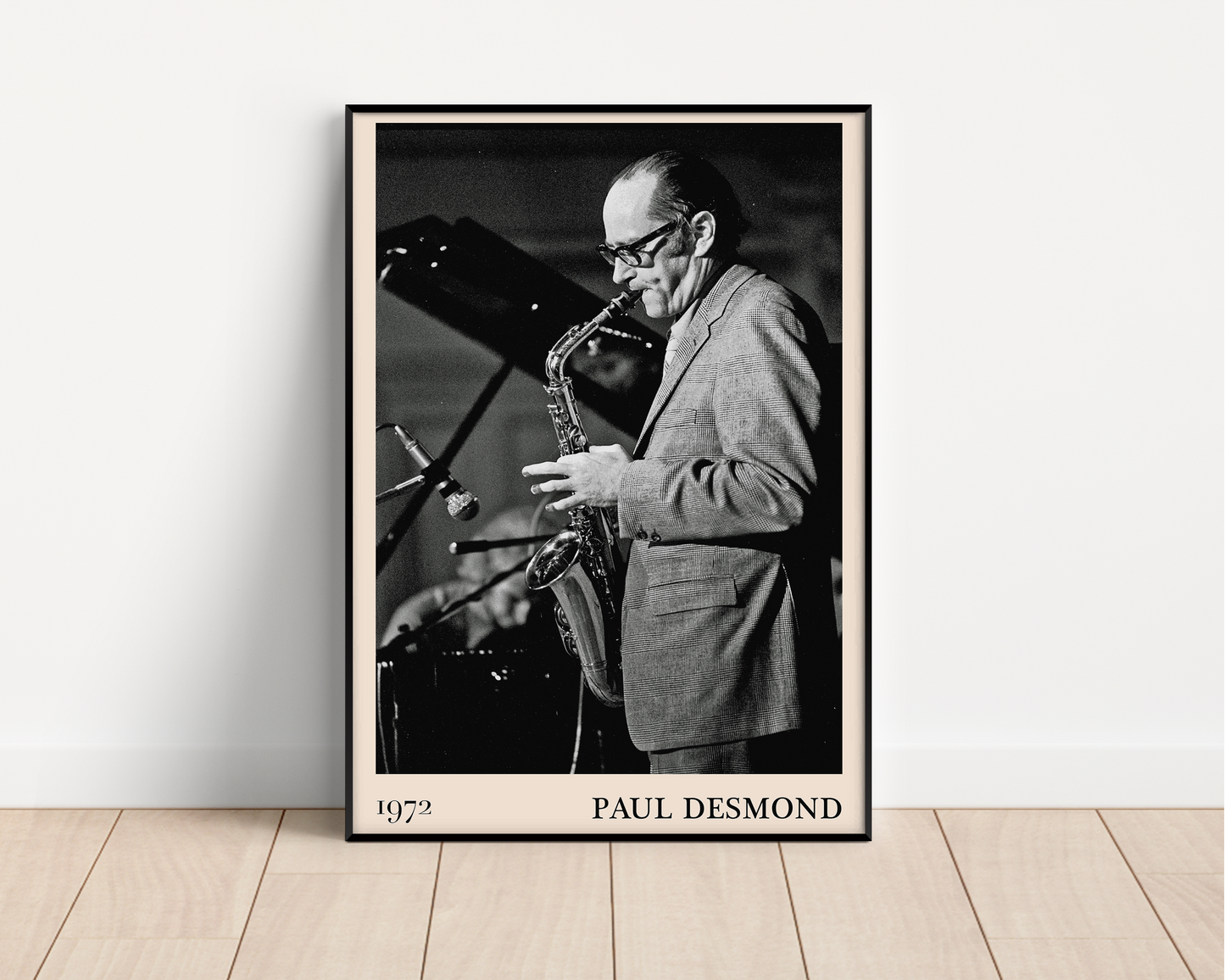 1972 photo of Paul Desmond crafted into a black framed-poster, leaning against a white wall