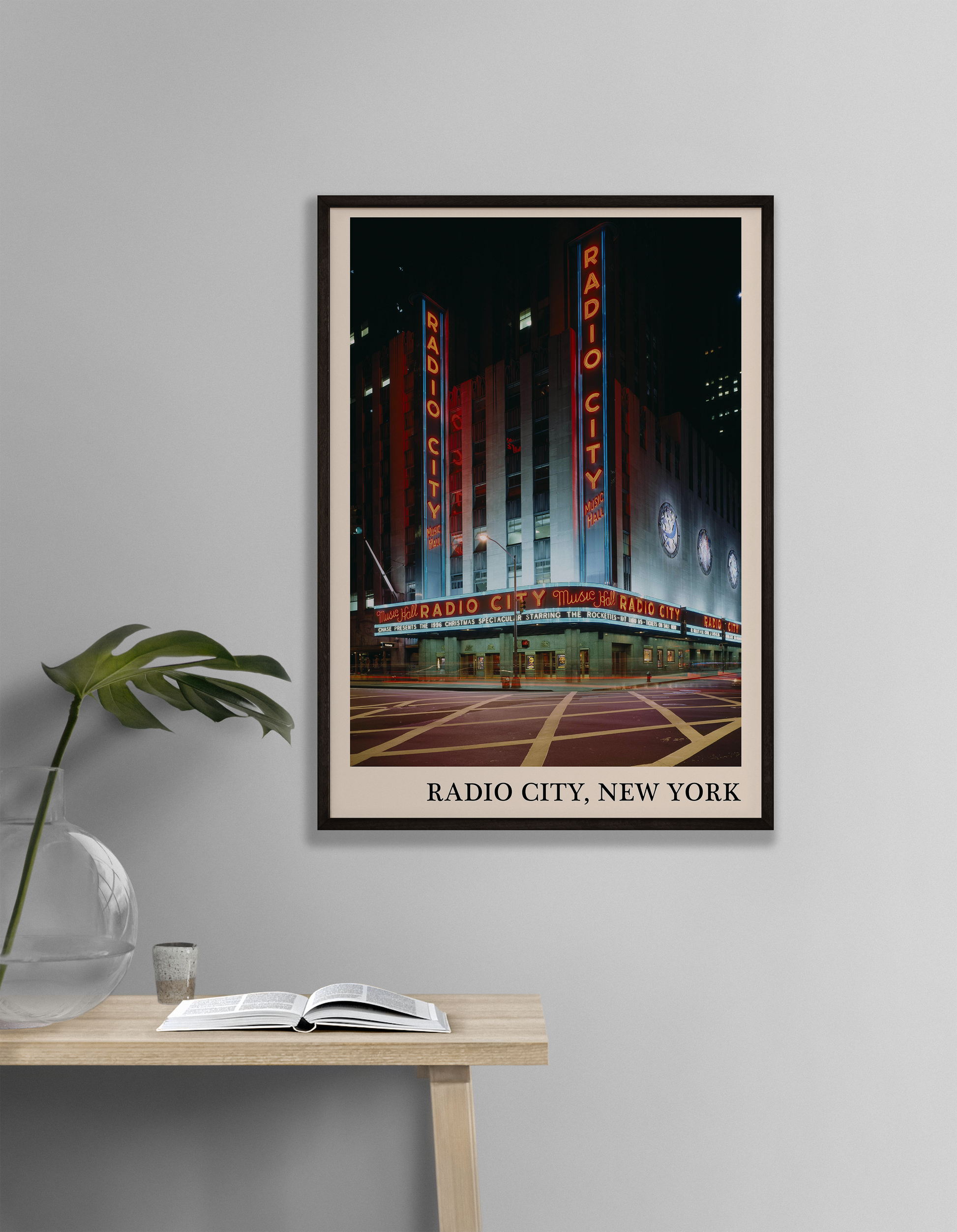 Iconic photo of Radio City in New York captured in a retro black framed jazz venue print, hanging on a grey living room wall
