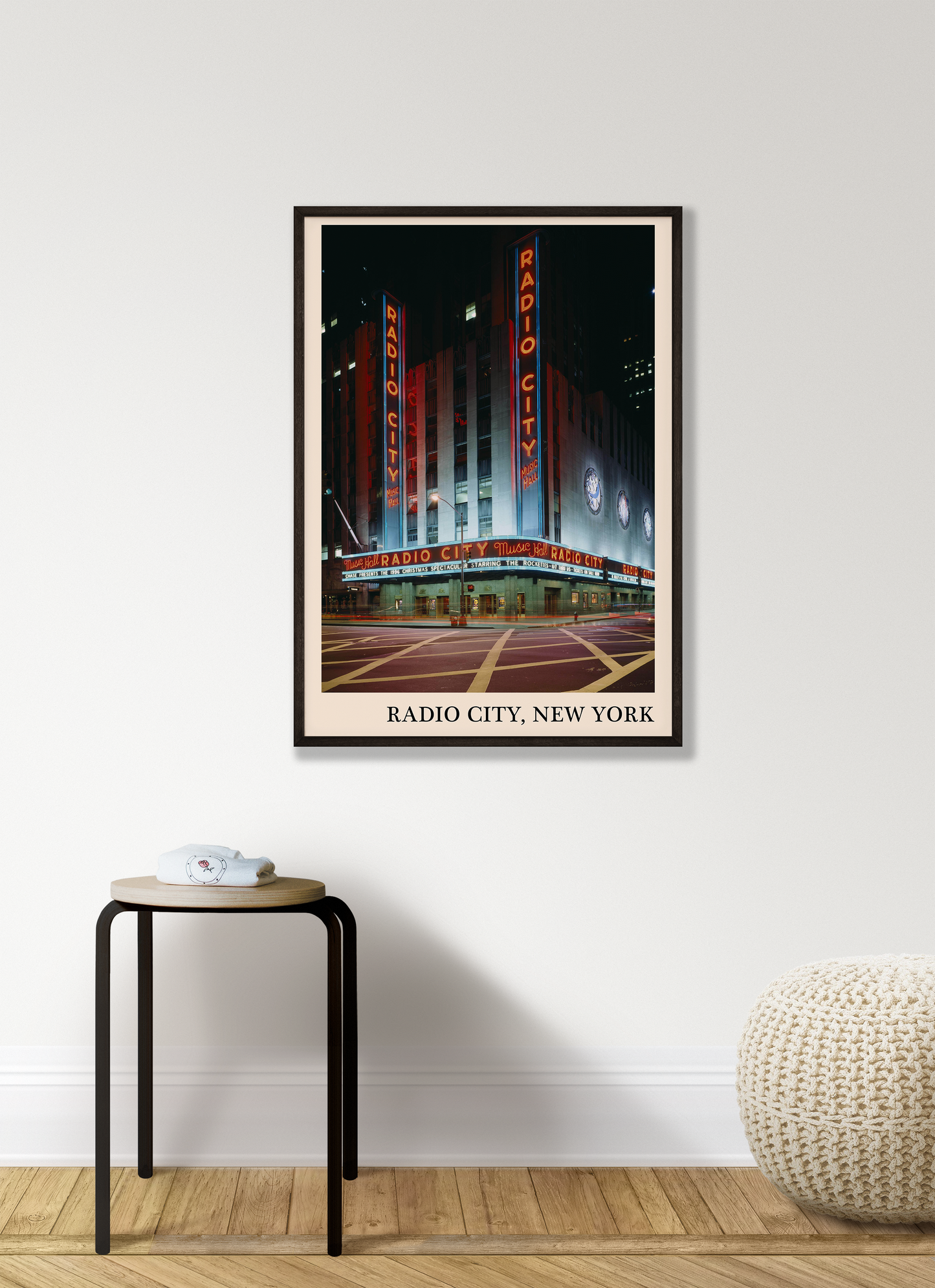 Iconic photo of Radio City in New York captured in a retro black framed jazz venue poster, hanging on a white living room wall