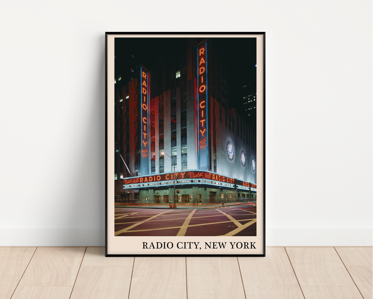 Iconic photo of Radio City in New York captured in a retro black framed jazz poster, leaning against a white wall