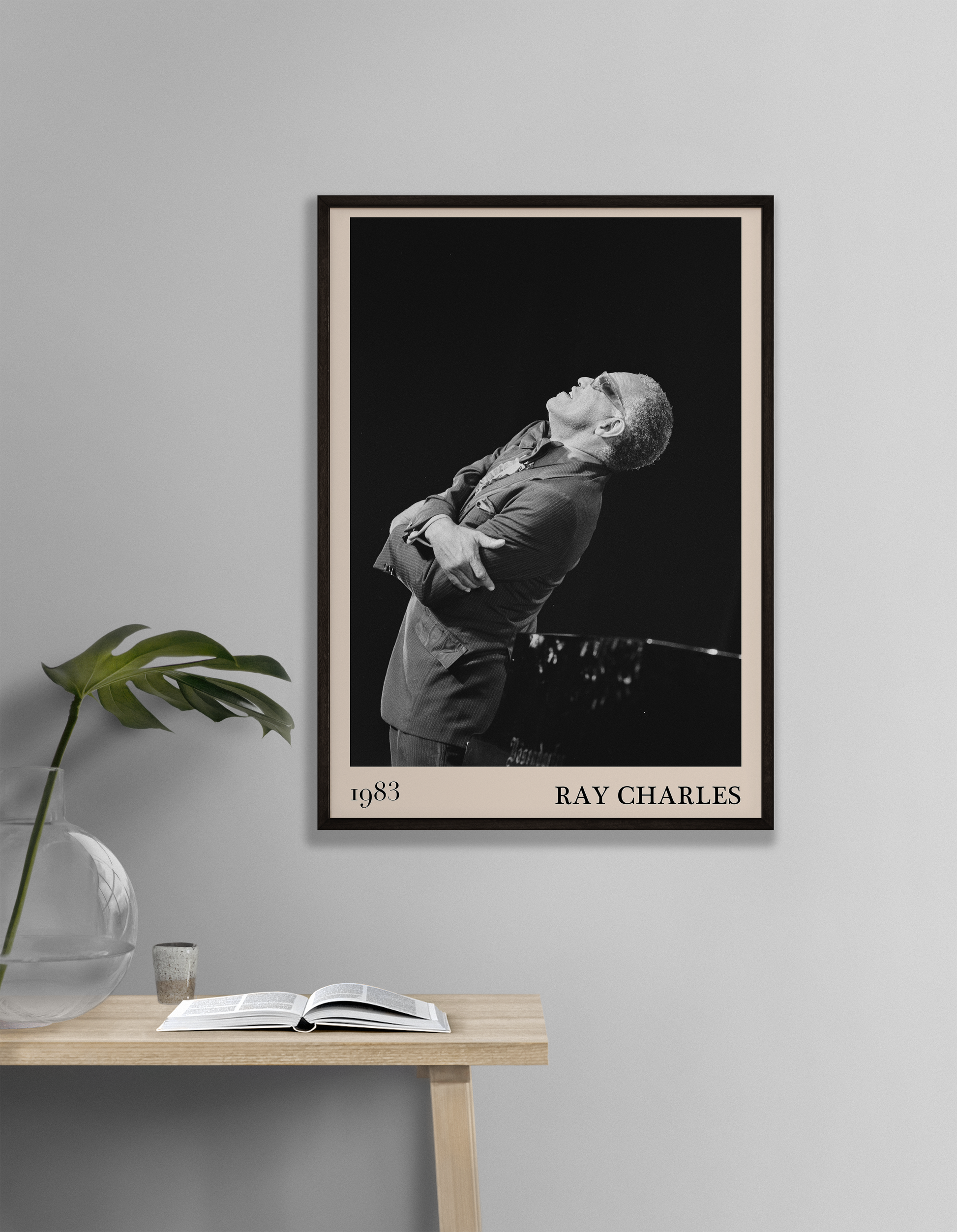 1983 photograph of Ray Charles singing, transformed into a stylish black-framed jazz poster leaning on white living room wall