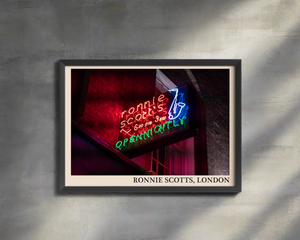 Iconic photo of Ronnie Scotts jazz club in London. Picture crafted into a black framed poster, with an off-white border. Poster is hanging up on a grey wall
