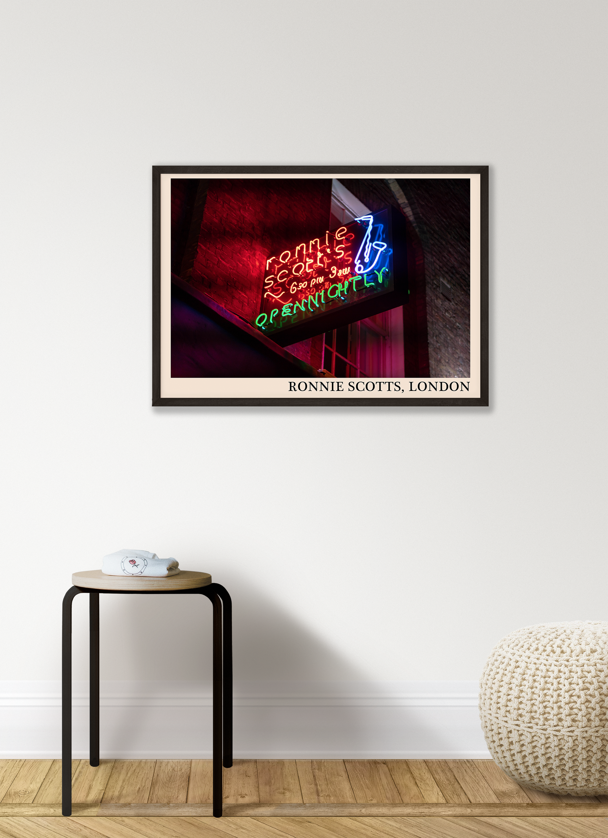 Iconic photo of Ronnie Scotts jazz club in London. Picture crafted into a retro black framed jazz print, with an off-white border. Poster is hanging on a grey living wall
