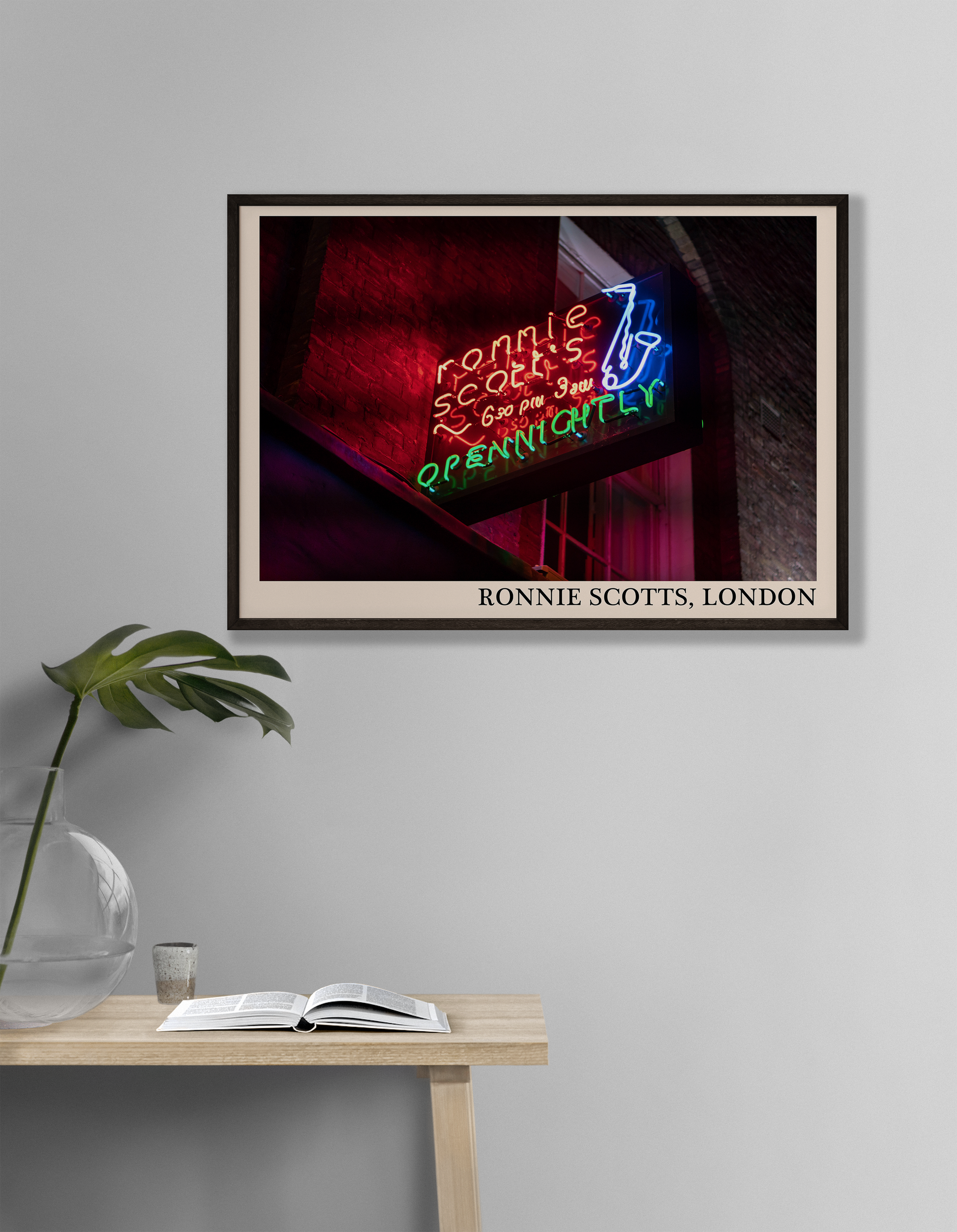 Iconic photo of Ronnie Scotts jazz club in London. Picture crafted into a cool black framed jazz print, with an off-white border. Poster is hanging on a grey living room wall