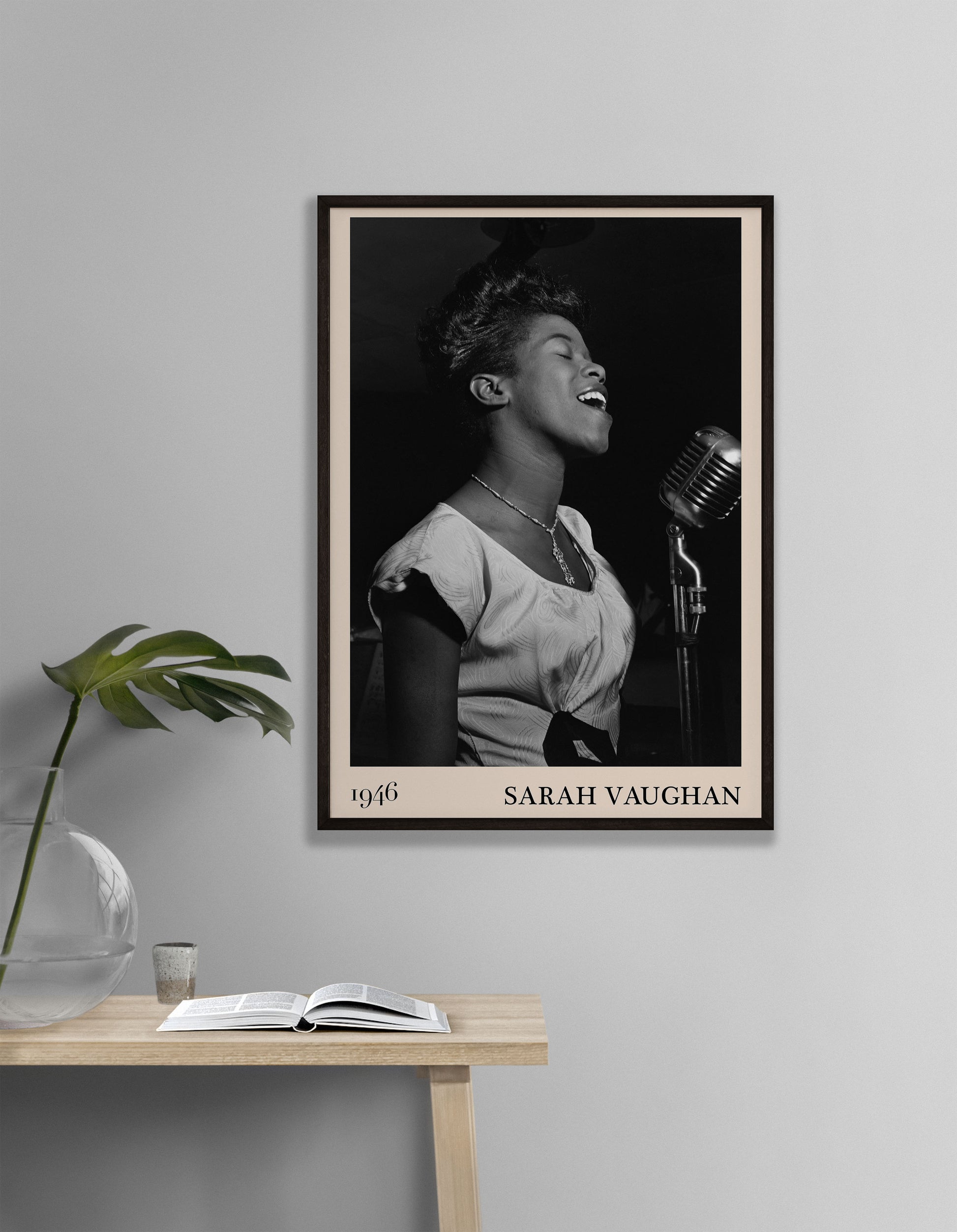 1946 photograph of Sarah Vaughan crafted into a retro black framed jazz print. The poster is hanging on a gry living room wall.