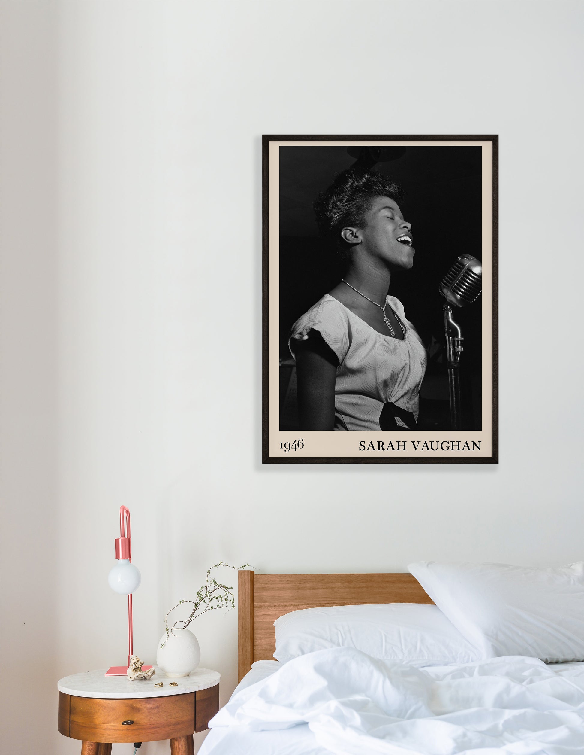 1946 photograph of Sarah Vaughan crafted into a retro black framed jazz print. The poster is hanging on a white bedroom wall.