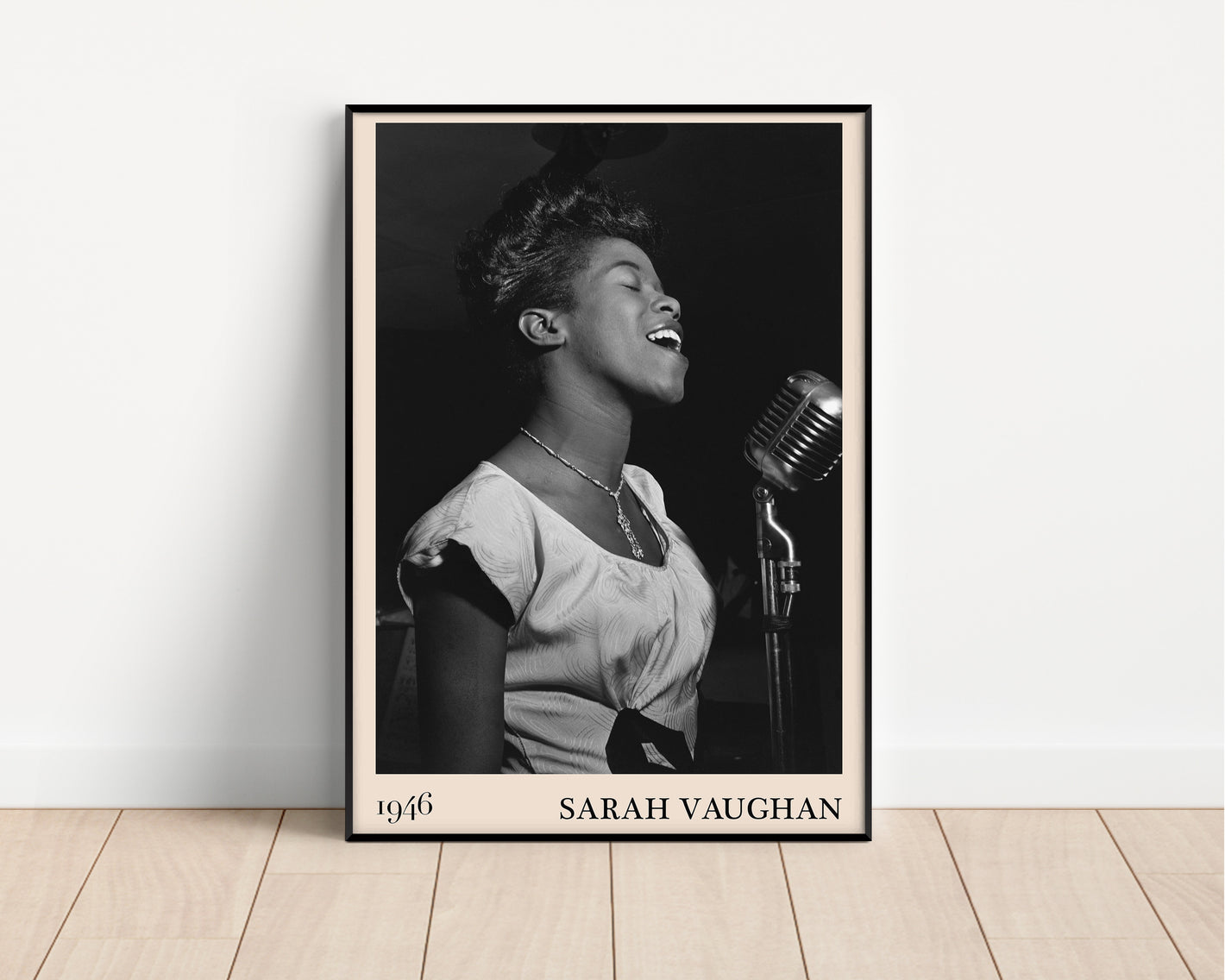 1946 photograph of Sarah Vaughan crafted into a black framed poster. The poster is resting on a white living room wall.