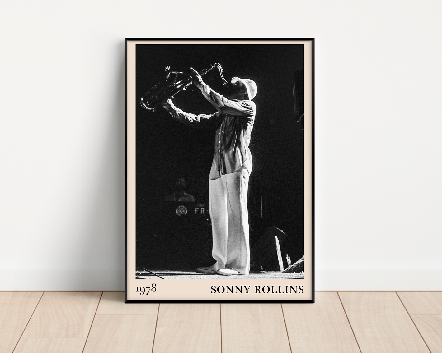 1978 photograph of Sonny Rollins playing the saxophone, transformed into a stylish black-framed jazz poster resting against a white wall
