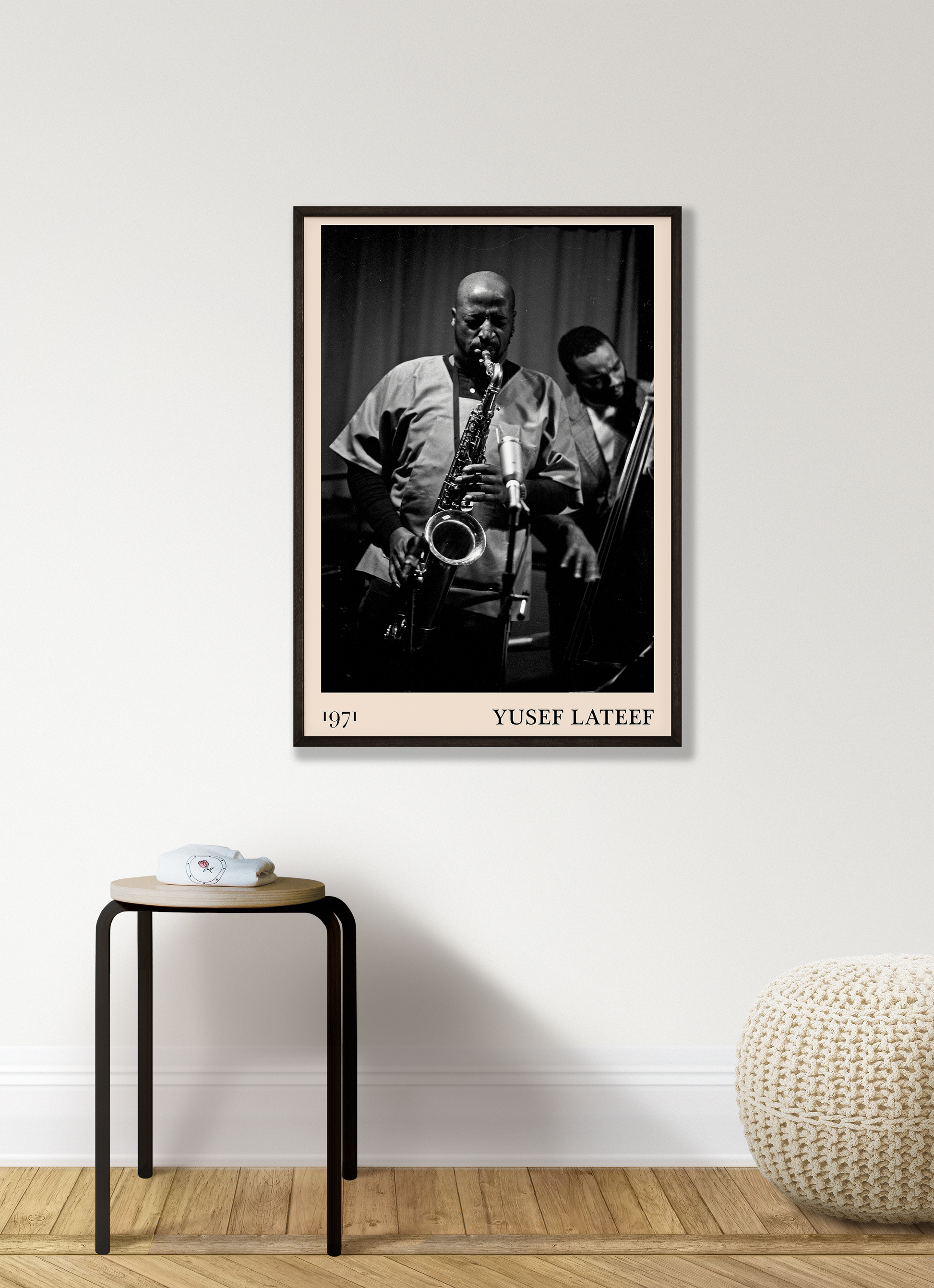 1971 photo of Yusef Lateef crafted into a black framed-poster, hanging on a white living room wall