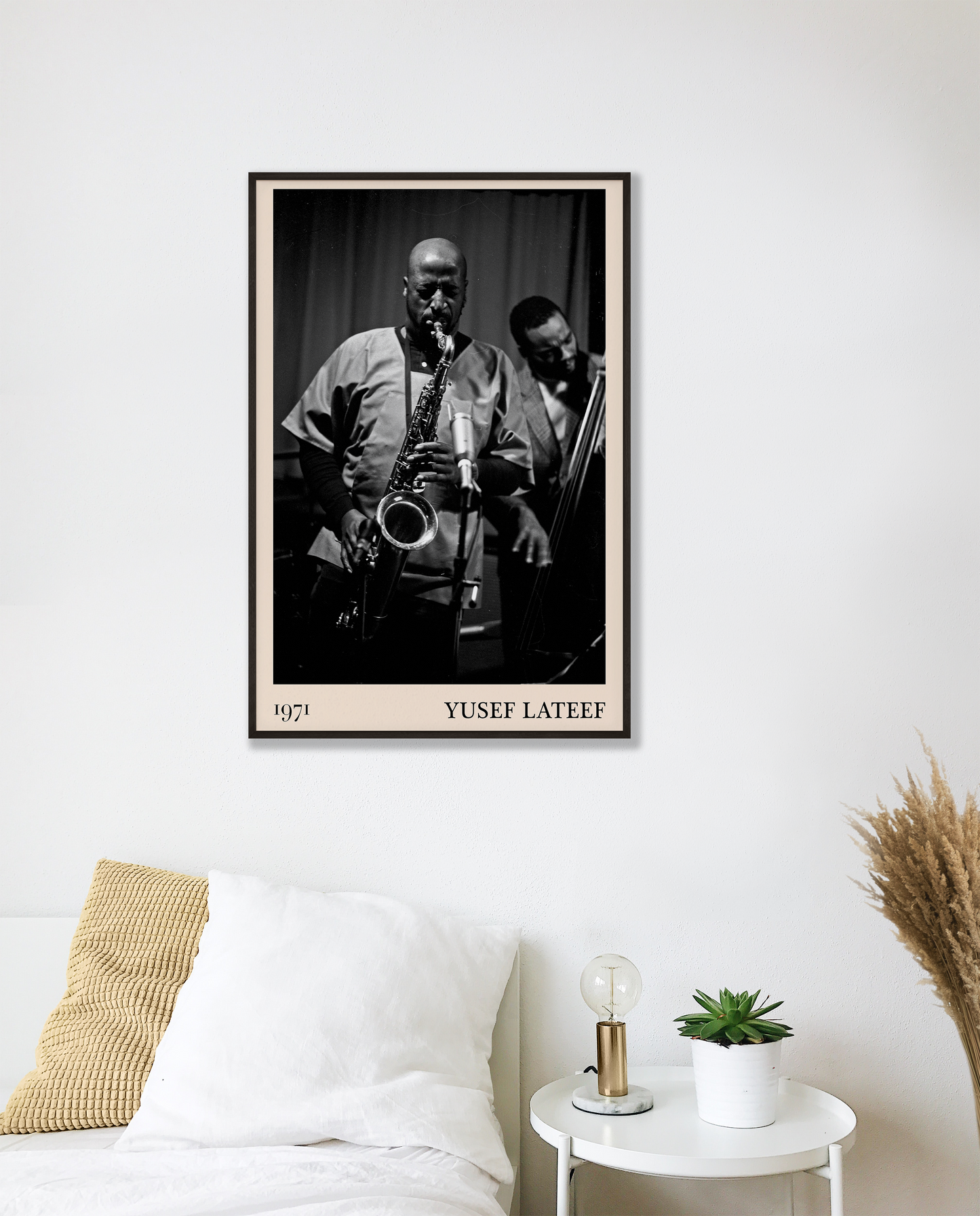 1971 photo of Yusef Lateef crafted into a black framed-poster, hanging on a white bedroom wall